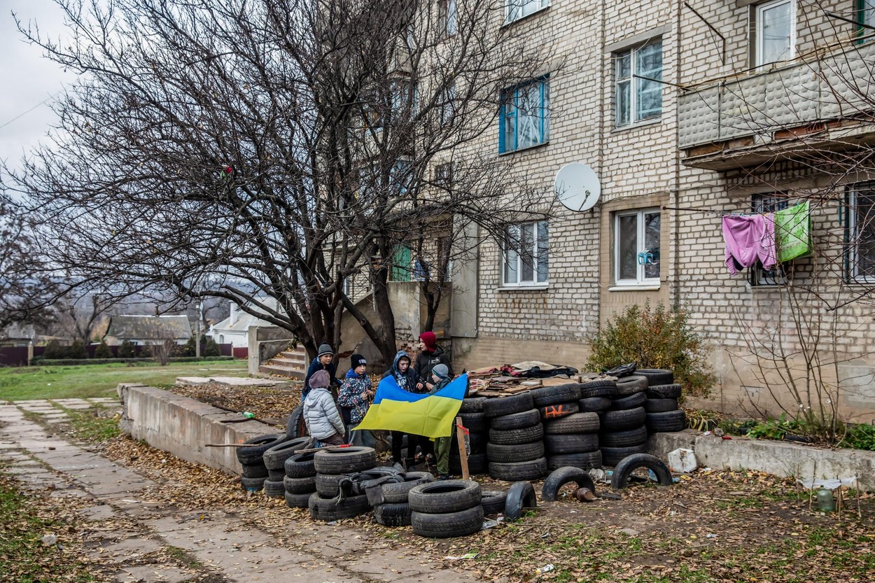 Donetsk, Ukraine. 12th Nov, 2022. Local kids have built a checkpoint out of old tires and are playing military on the city street. Credit: SOPA Images Limited/Alamy Live News