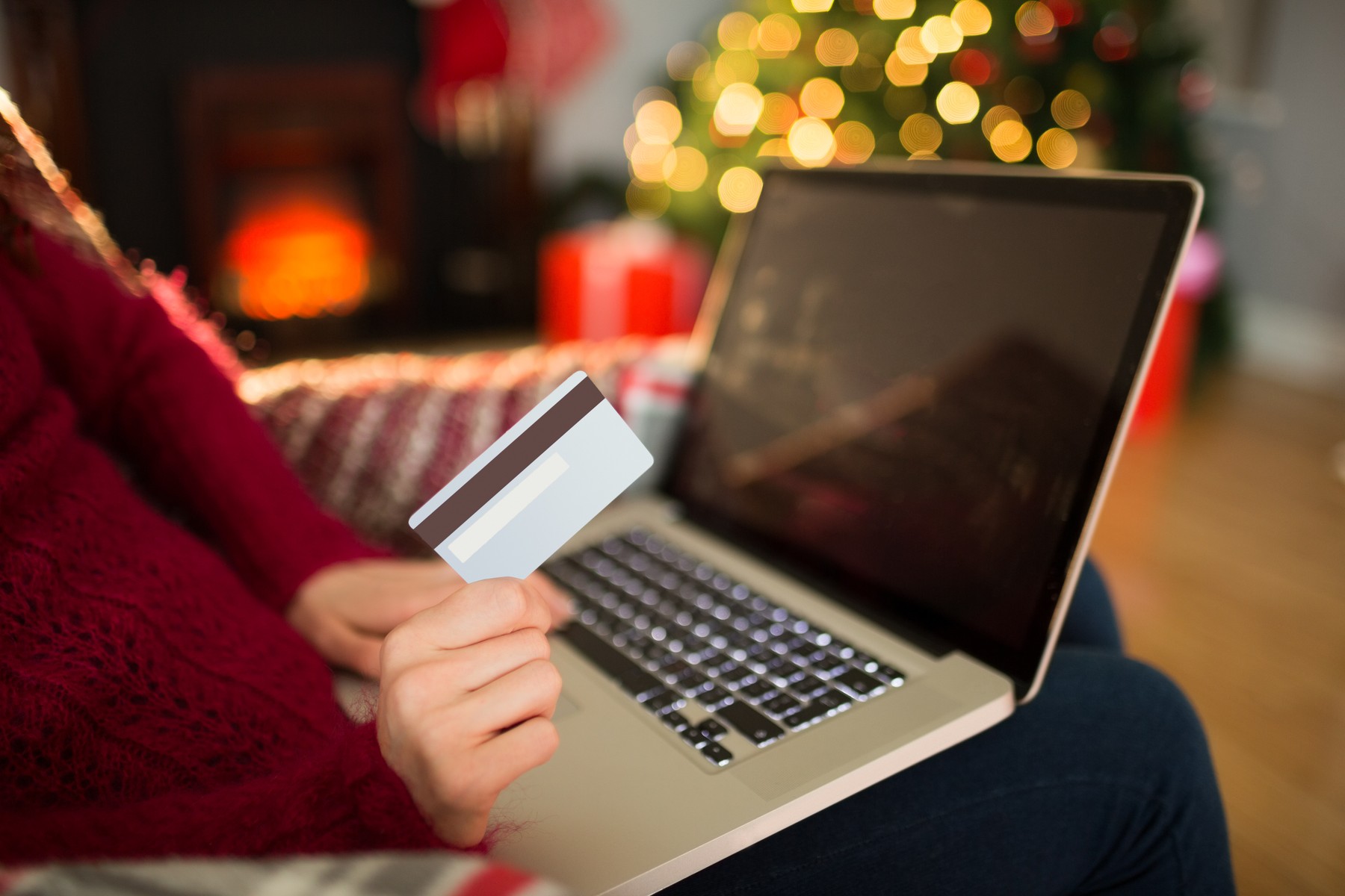 Woman shopping online with laptop at christmas