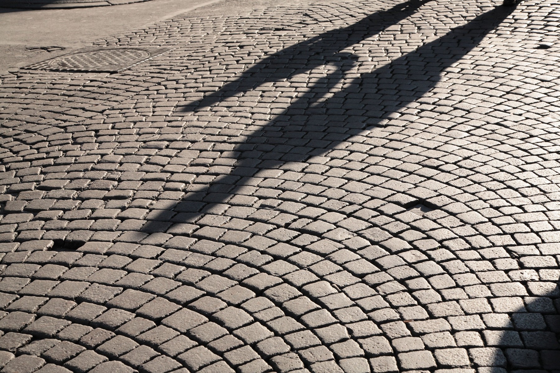 Shadows of parent and child holding hands, Italy