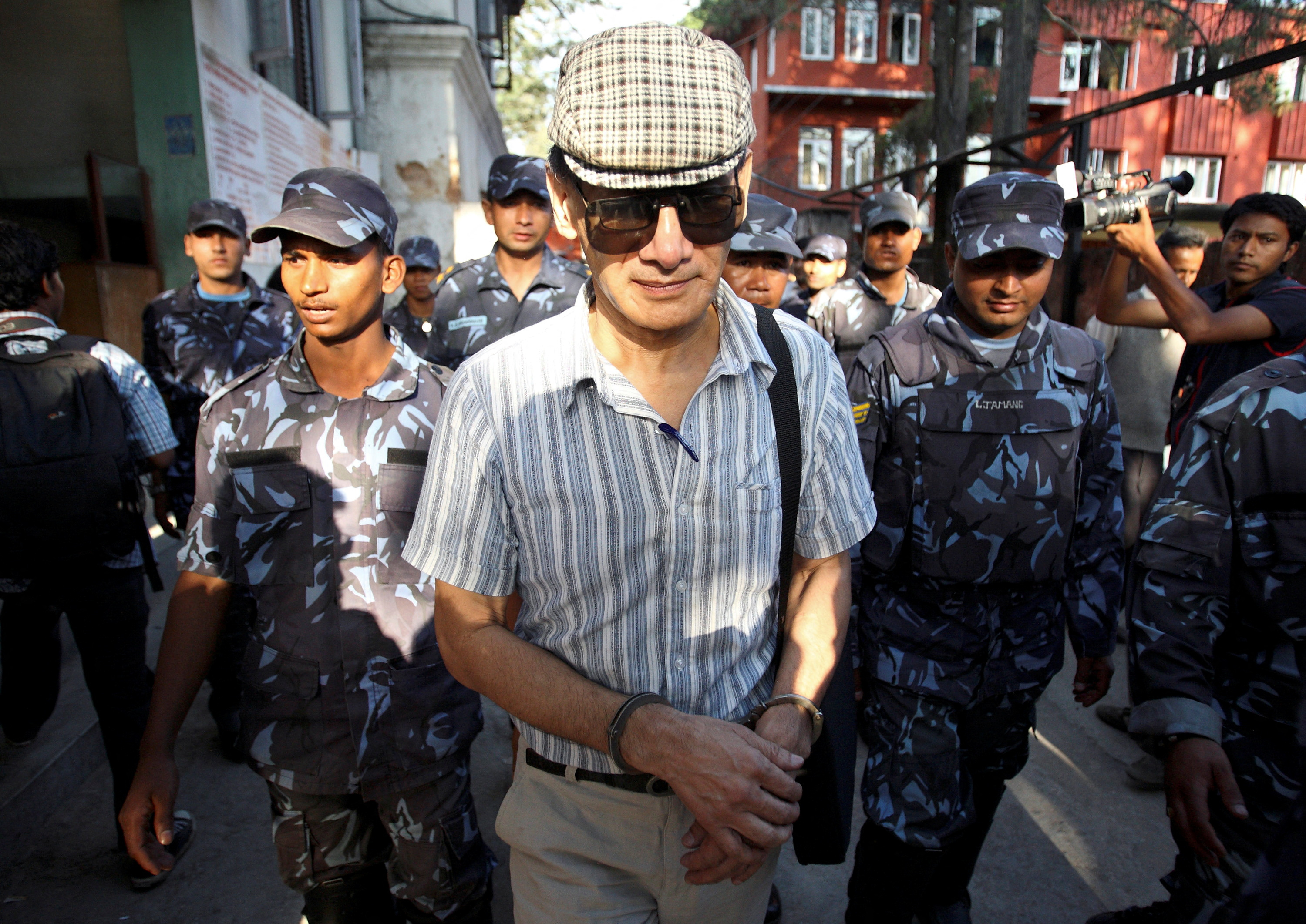 FILE PHOTO: French serial killer Charles Sobhraj leaves Kathmandu district court after his hearing in Kathmandu