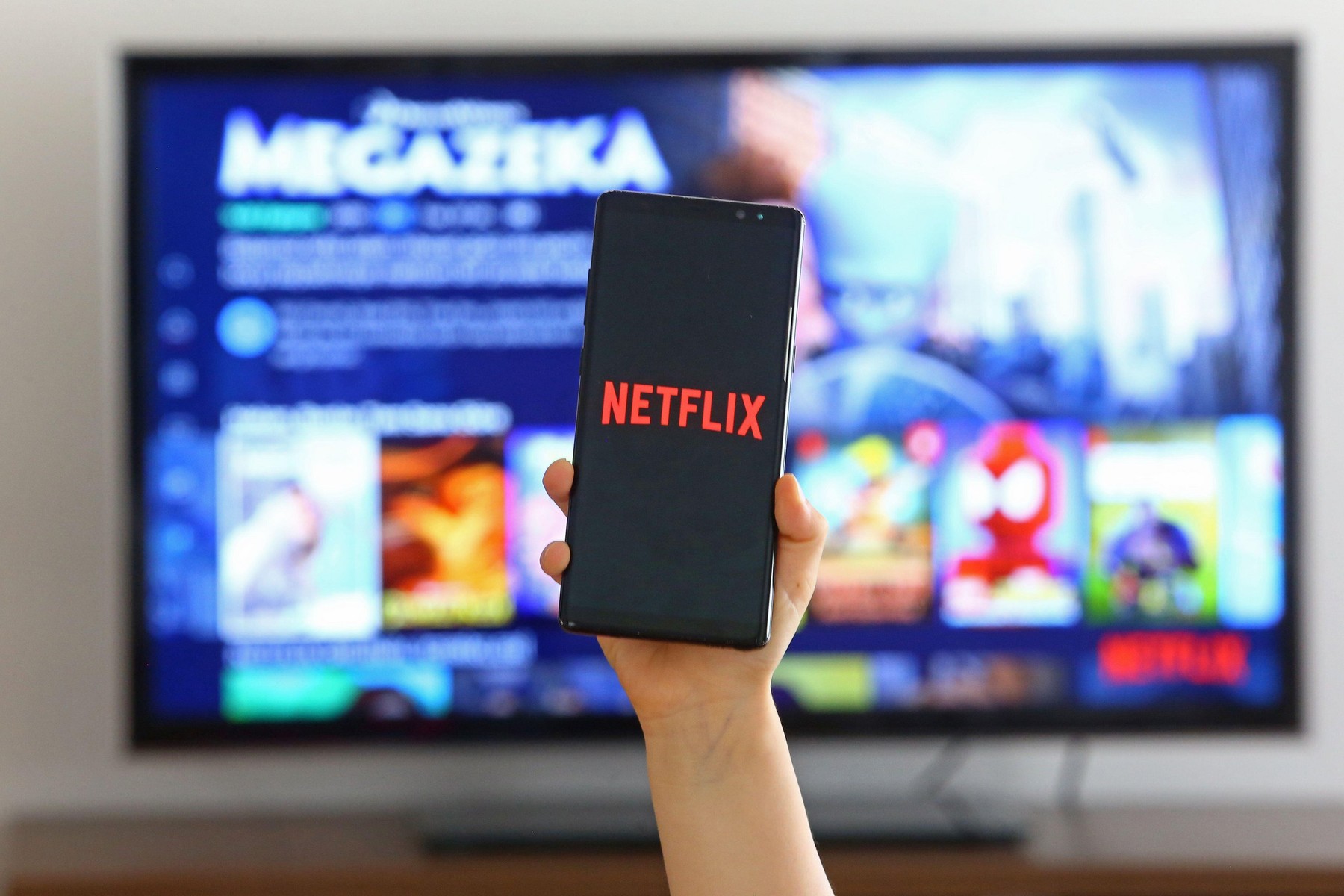 7 April 2020. Children is using Neflix application on her TV. Netflix is an american entertainment company specialized in streaming media.