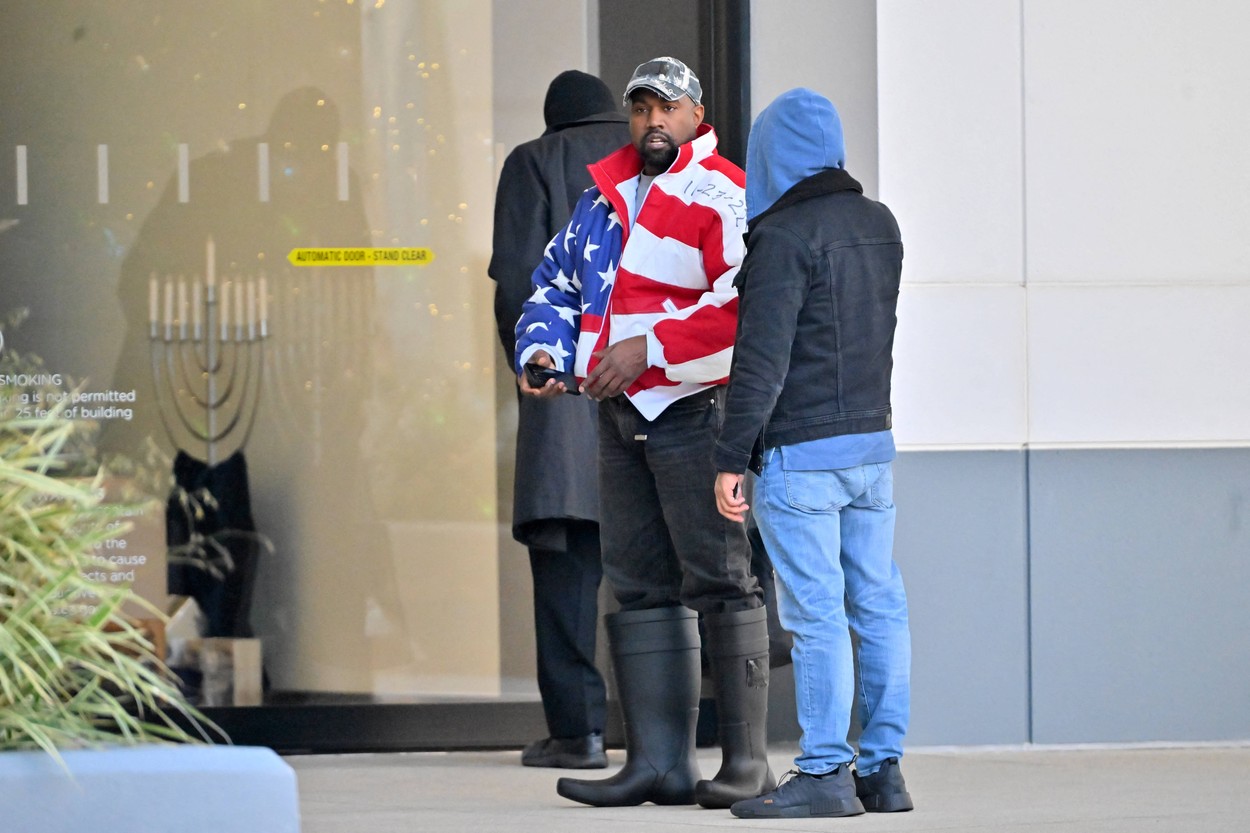 Kanye West heads to a meeting after heading to church wearing an American flag jacket