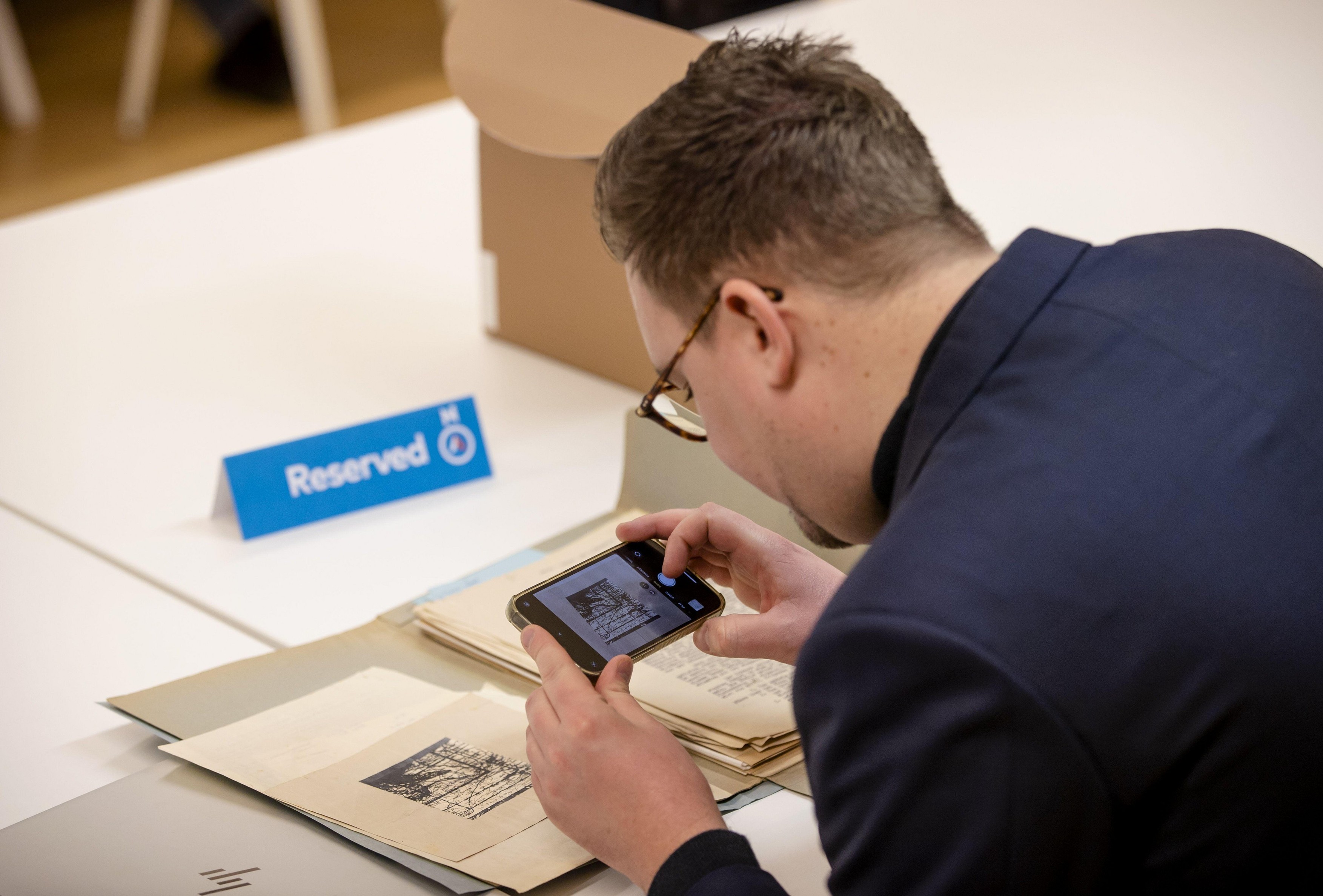 THE HAGUE - A journalist looks at a treasure map to a possible Nazi treasure in Ommeren in the National Archives during the annual Open Access Day. Many archive documents are made public on this day. ANP SEM VAN DER WAL netherlands out - belgium out