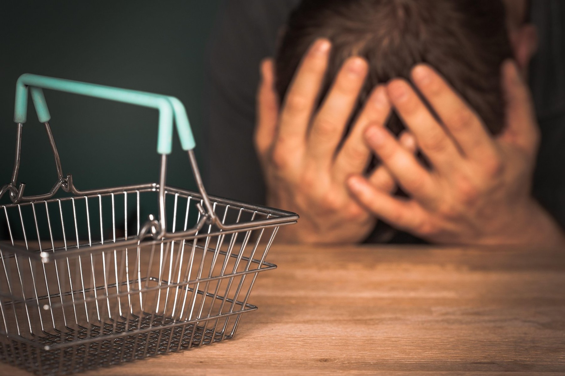 Miniature, empty shopping basket, A man holding his head, The concept of high prices and rising inflation, The problem of families and household budge