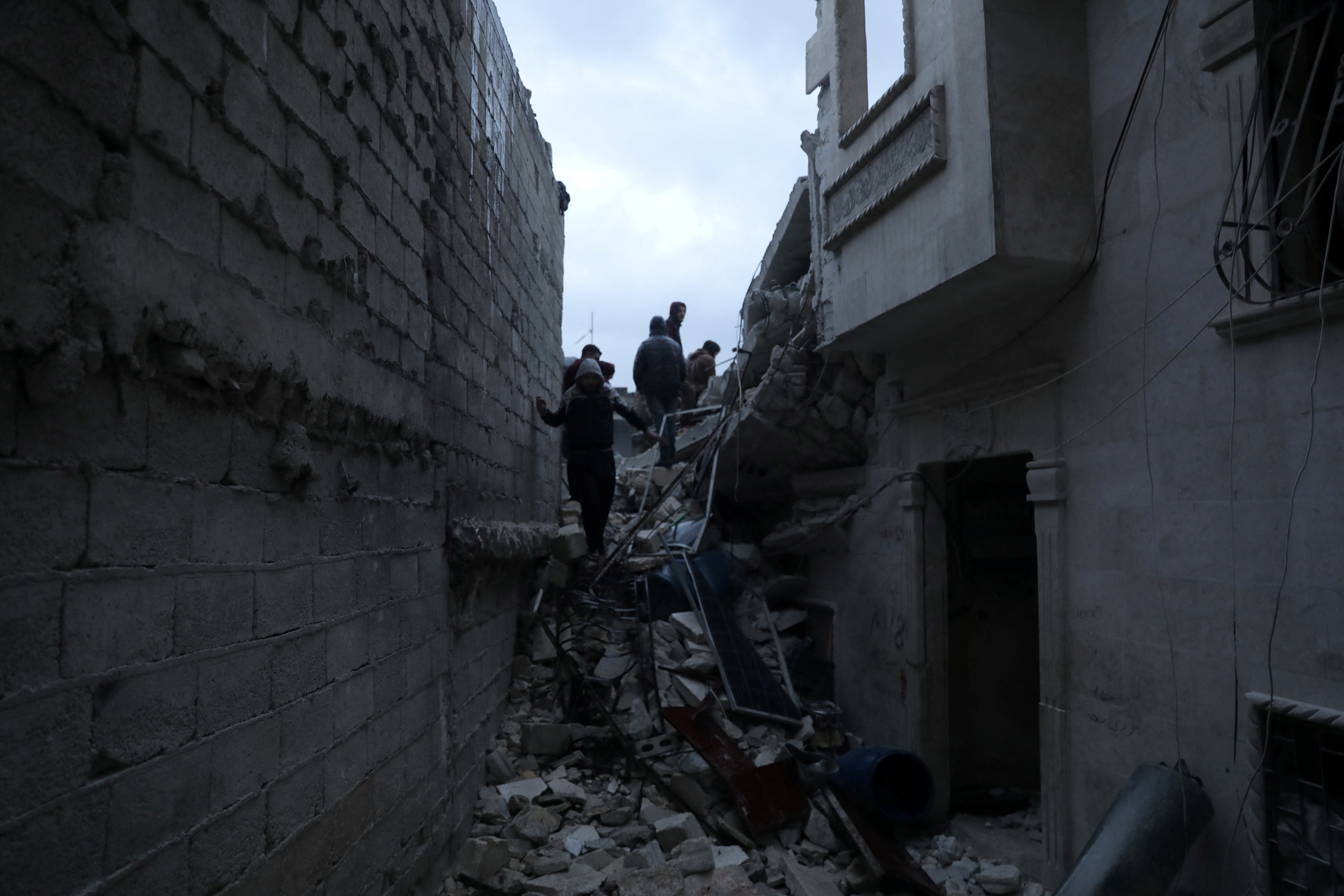 Rescuers search for survivors under the rubble following an earthquake in rebel-held Idlib