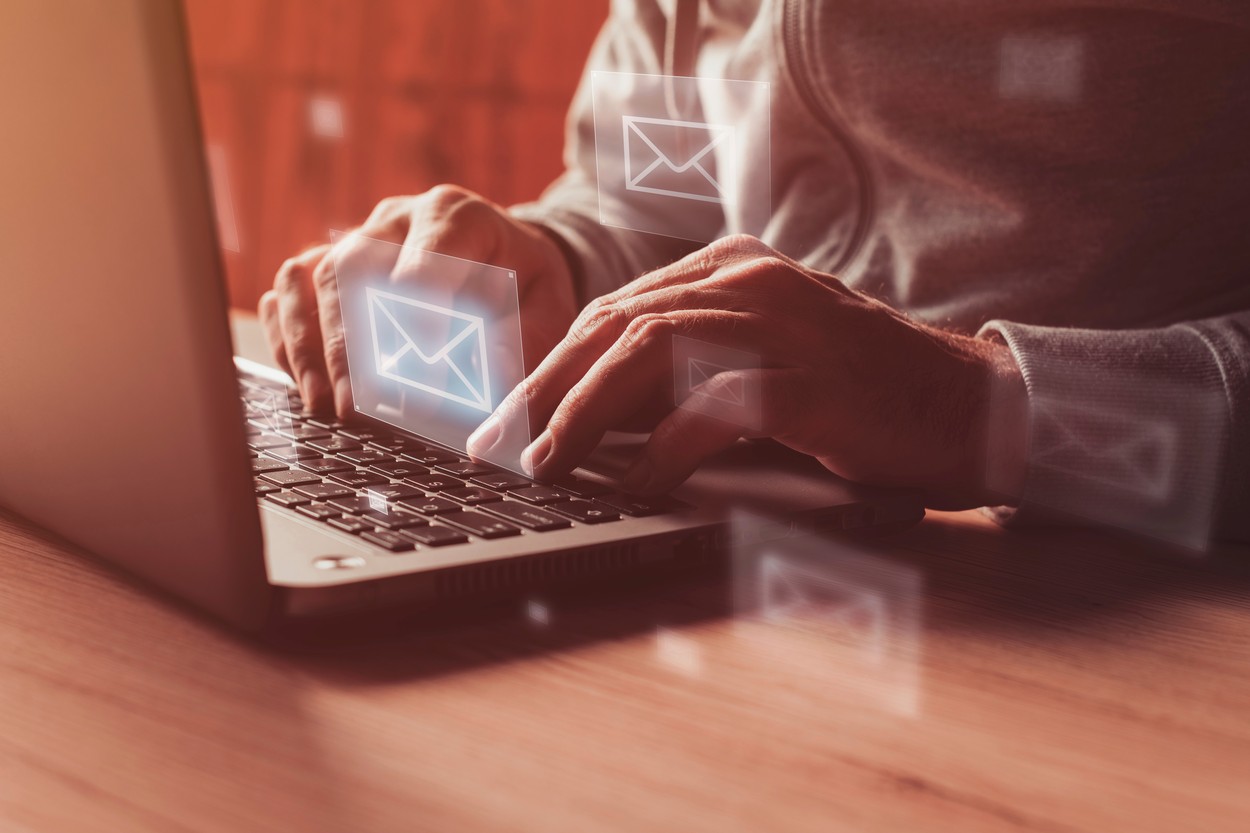 Man writing e-mail on laptop