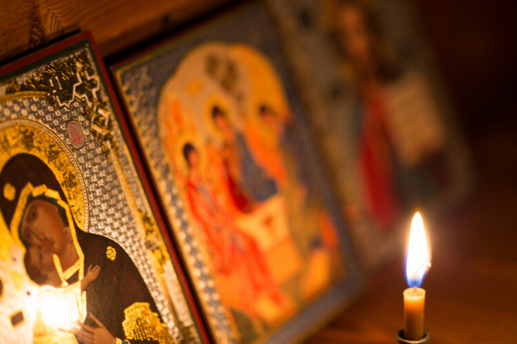 A,Burning,Candle,Against,The,Background,Of,Orthodox,Icons,In
