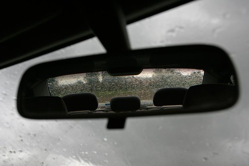 Rear view mirror in a car in the rain