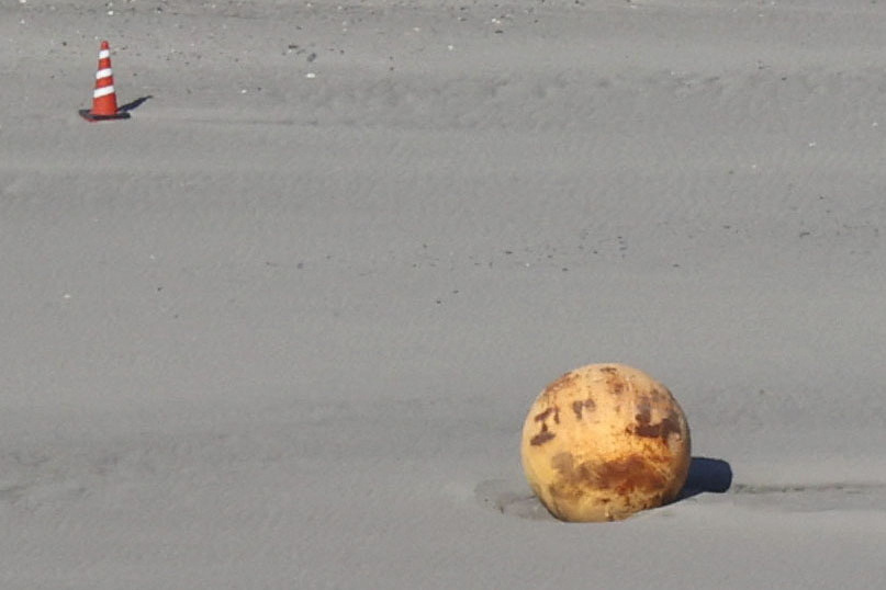 An aerial view shows a large metallic object which washed up on the Enshuhama Beach in Hamamatsu