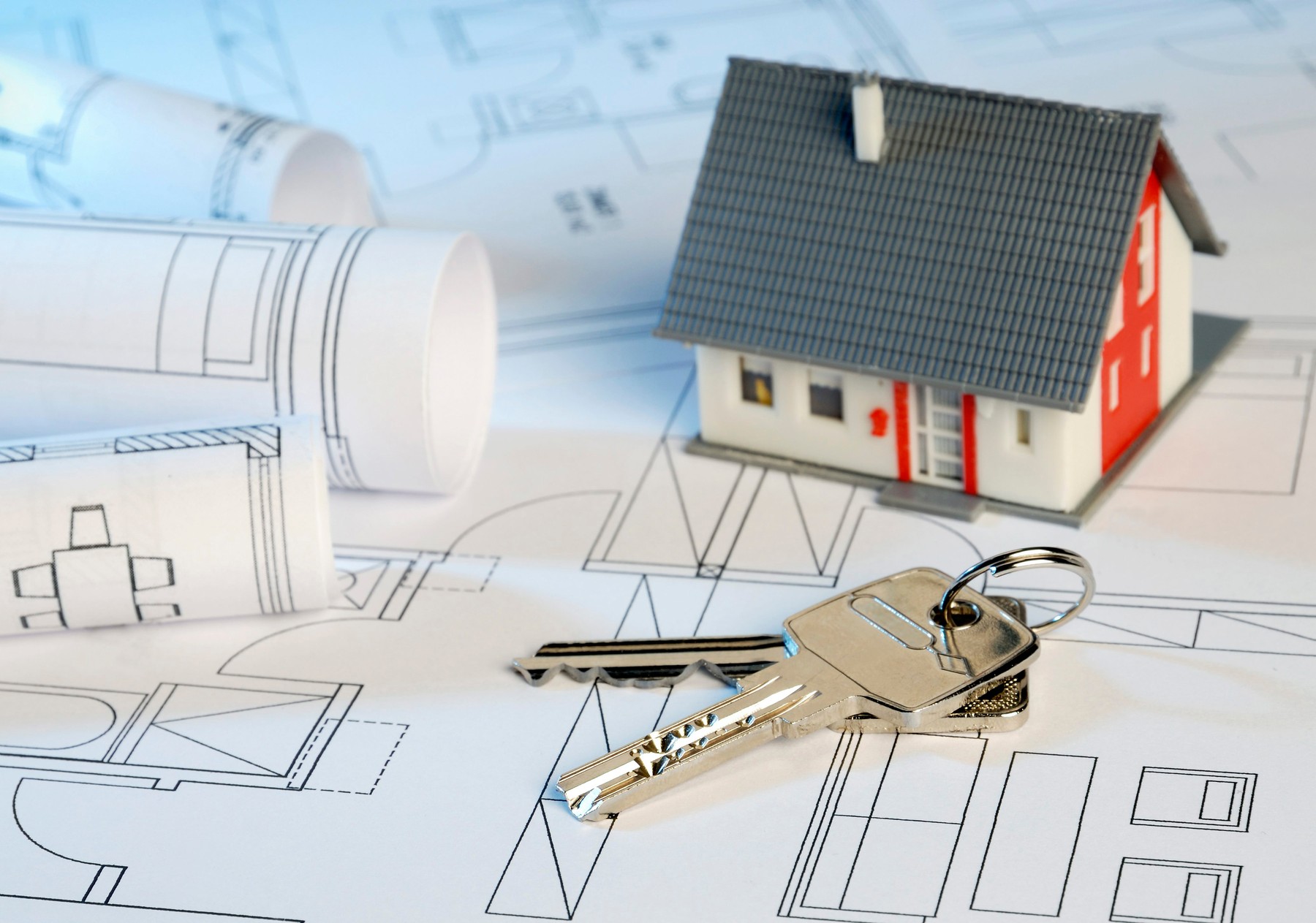 House with blueprints and key