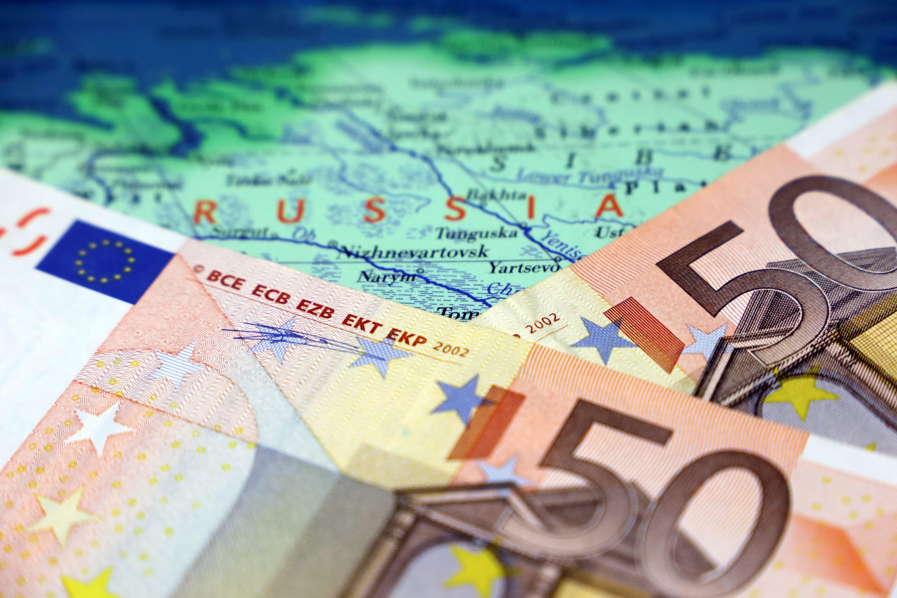 Euro banknotes on map of Russia. EU sanctions against the Russian economy, European currency ban