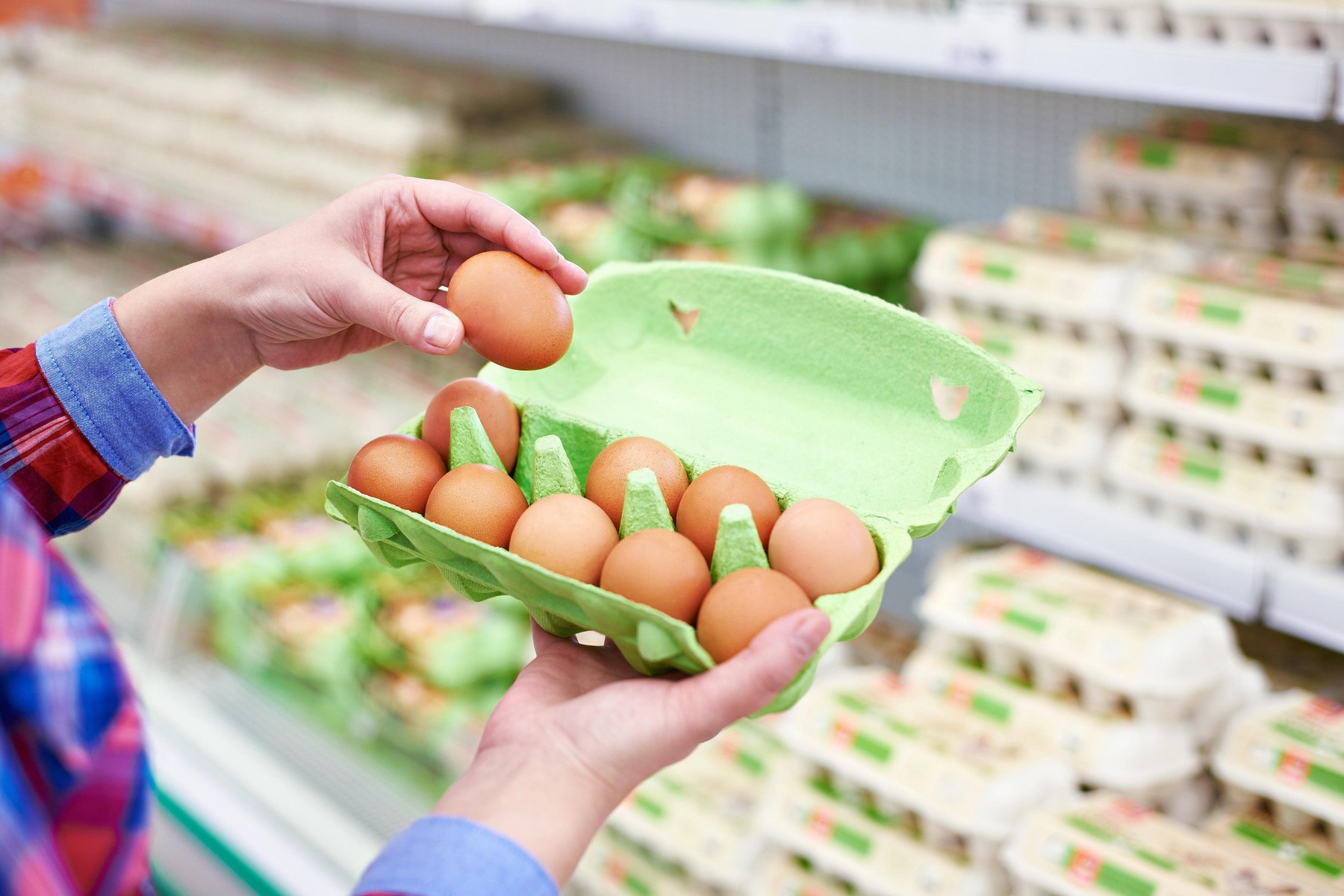 In the hands of a woman packing eggs in the supermarket