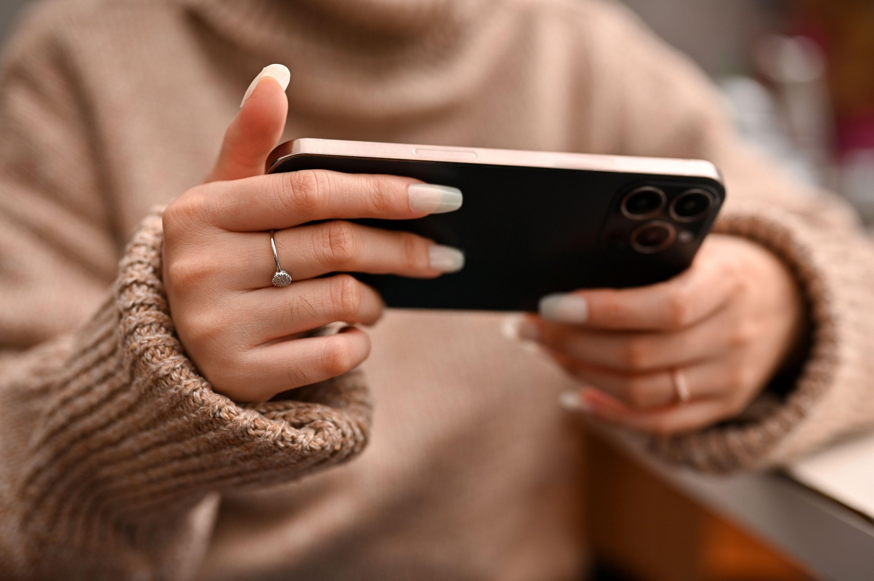 Close-up image, Female using a cellphone, watching some movie via smartphone, playing mobile game.