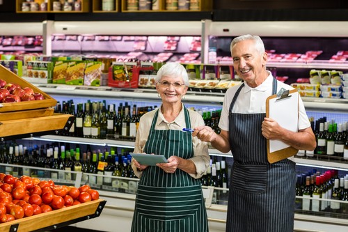 Smiling senior workers with clipboard