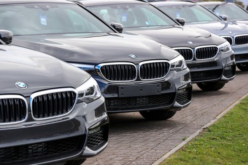 Line of new BMW 3 series saloons for sale, sitting at a garage forecourt,