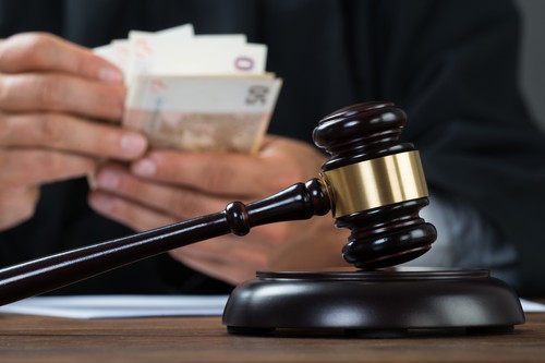 Judge Counting Money At Table
