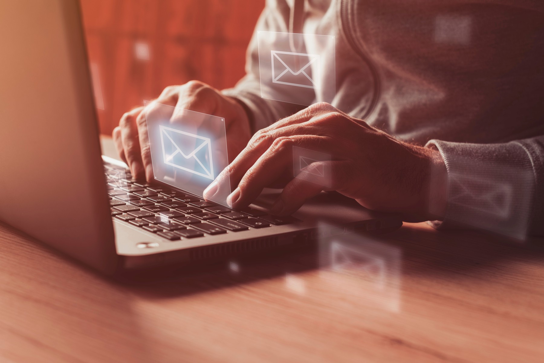 Man writing e-mail on laptop