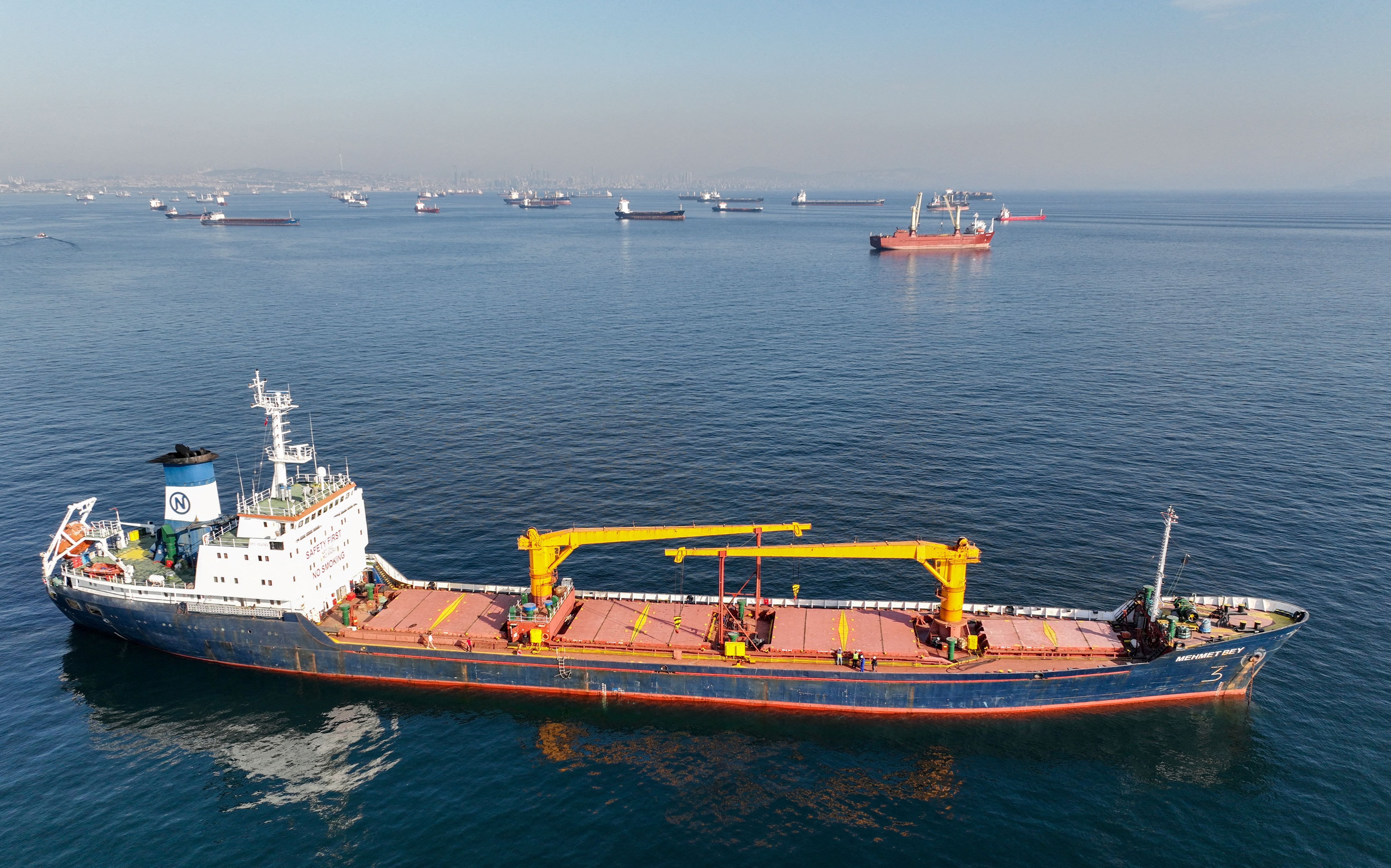 FILE PHOTO: Commercial vessels including vessels which are part of Black Sea grain deal wait to pass the Bosphorus strait off the shores of Yenikapi in Istanbul