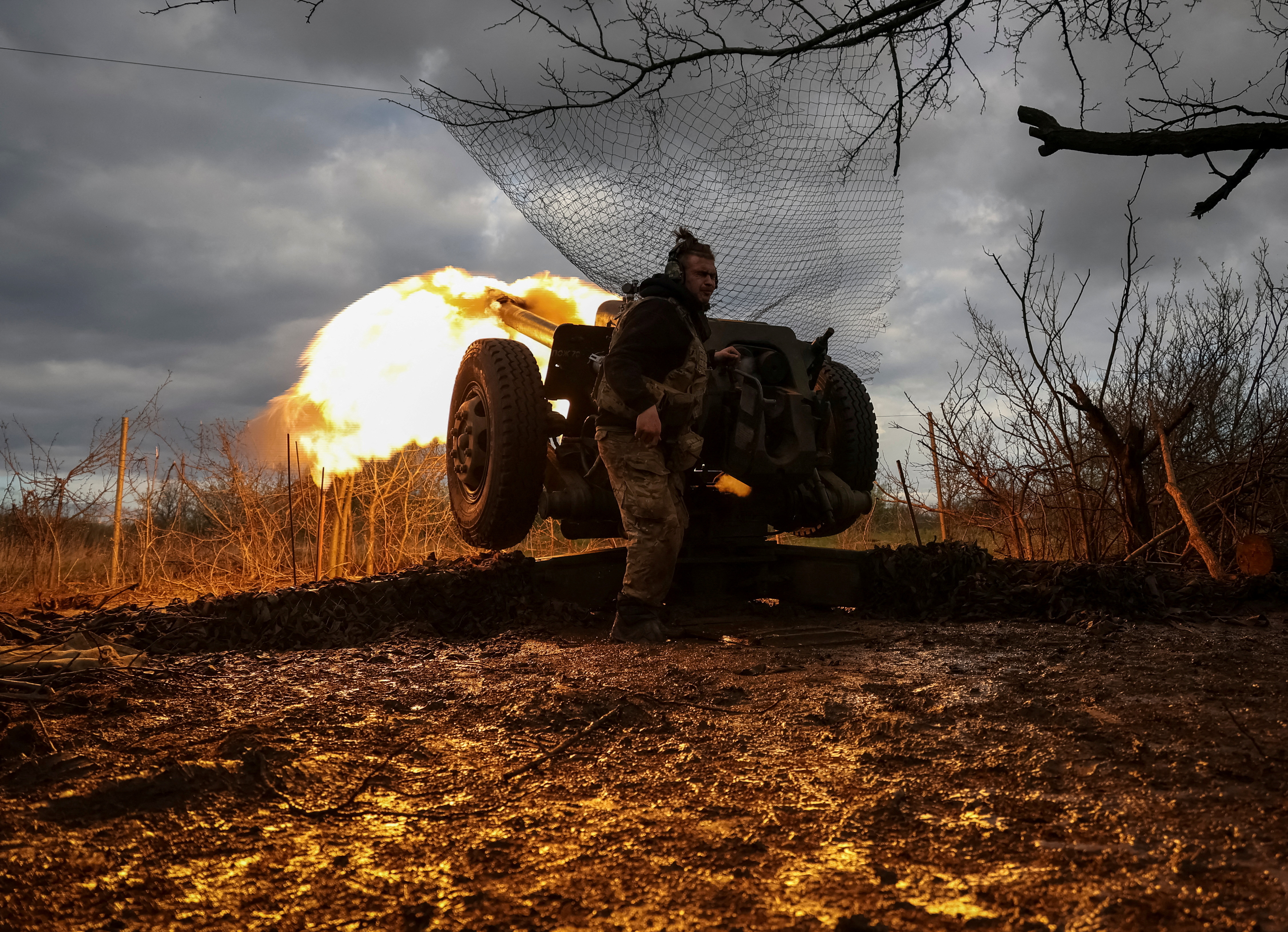FILE PHOTO: Ukrainian service members fire a howitzer D30 at a front line near the city of Bakhmut