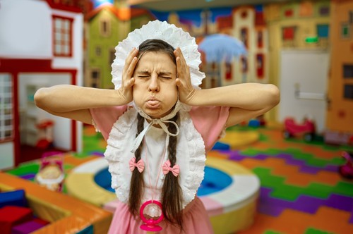 Portrait of funny woman like newborn baby grimacing