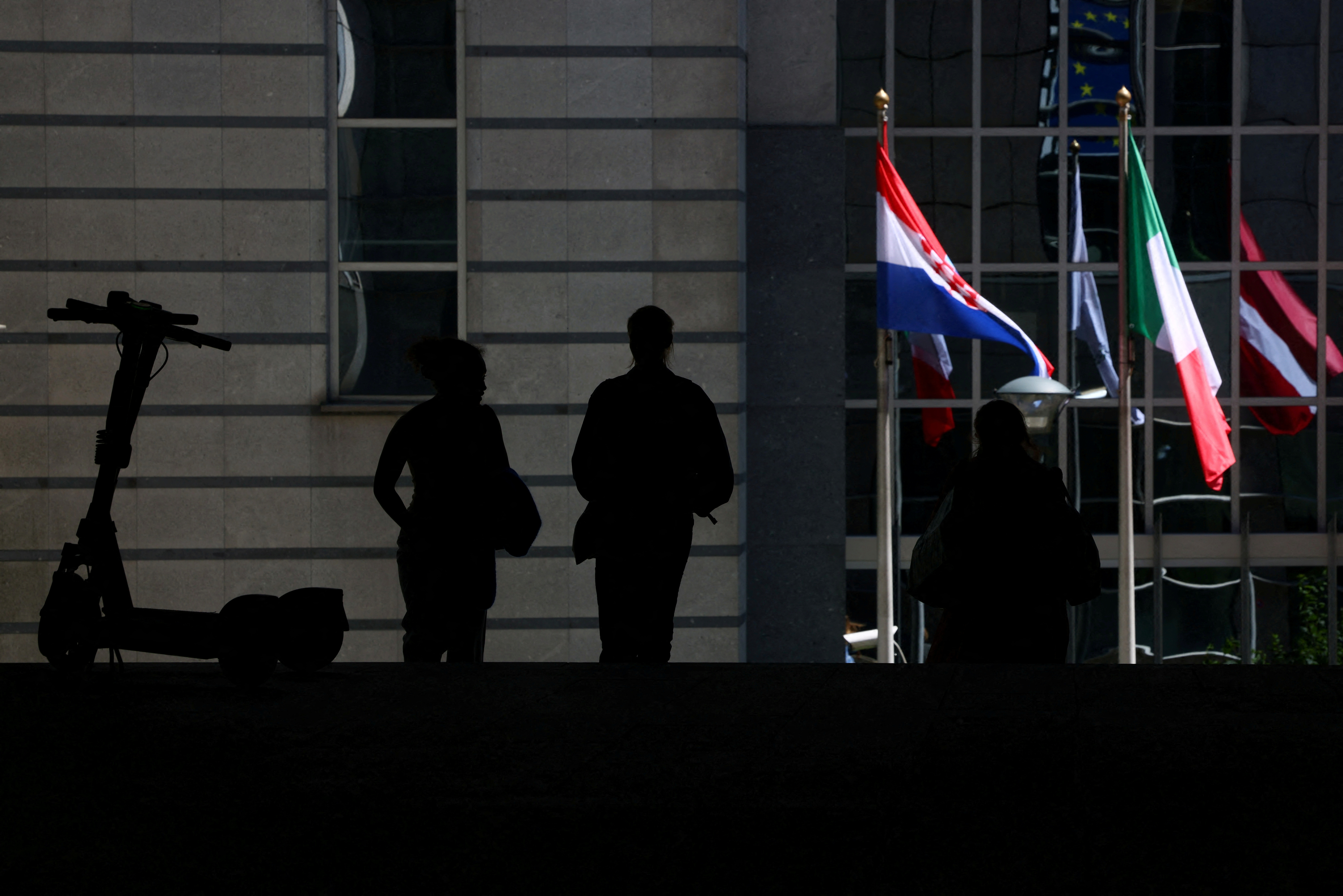 FILE PHOTO: People walk near the entrance of the European Parliament in Brussels