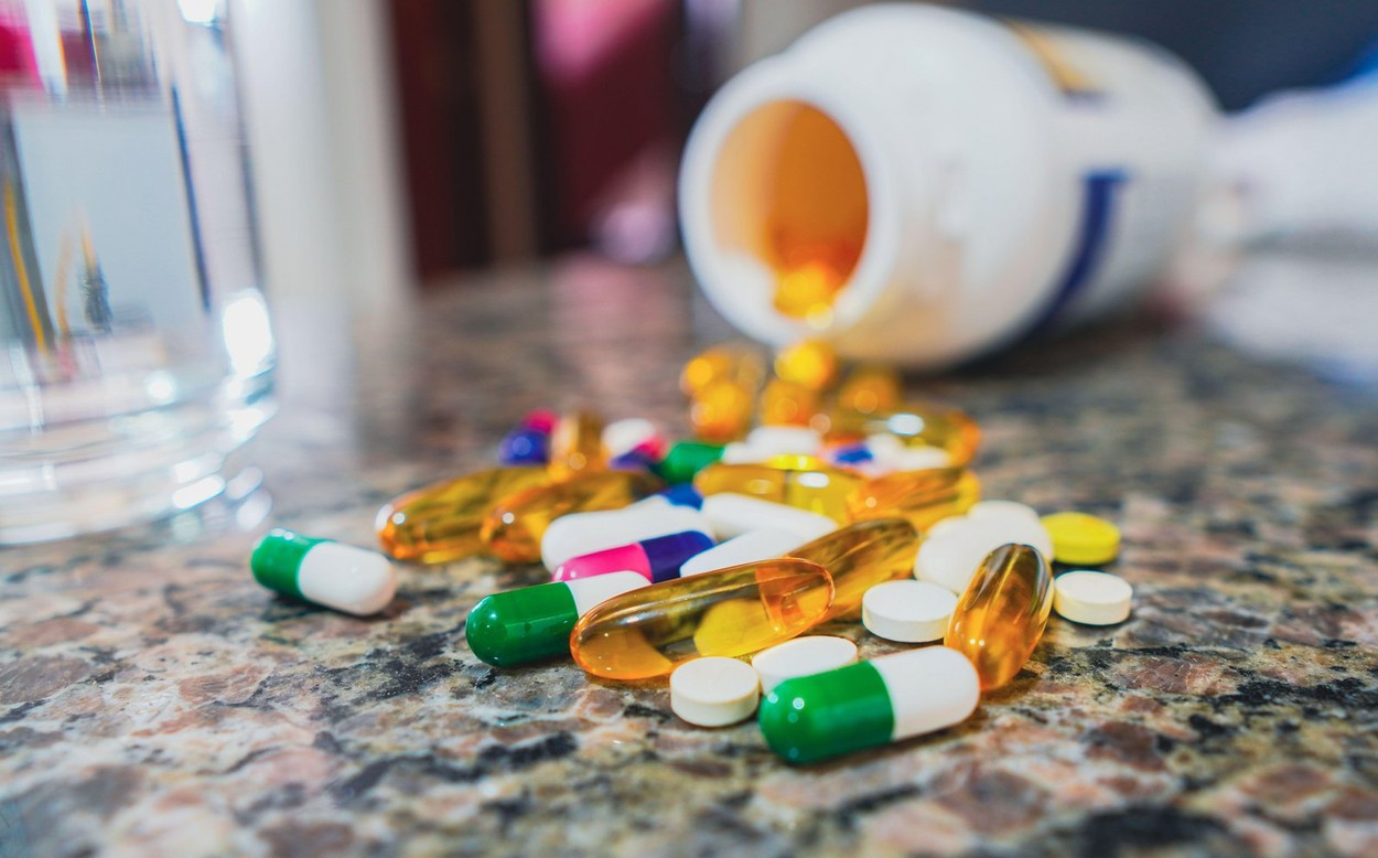 April 11, 2023, Brazil. In this photo illustration, a several pills on the table next to glass of water