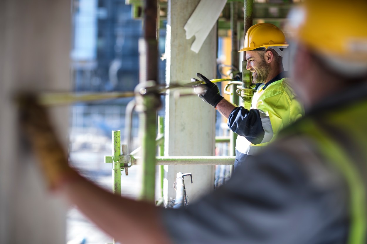 Construction workers measuring building