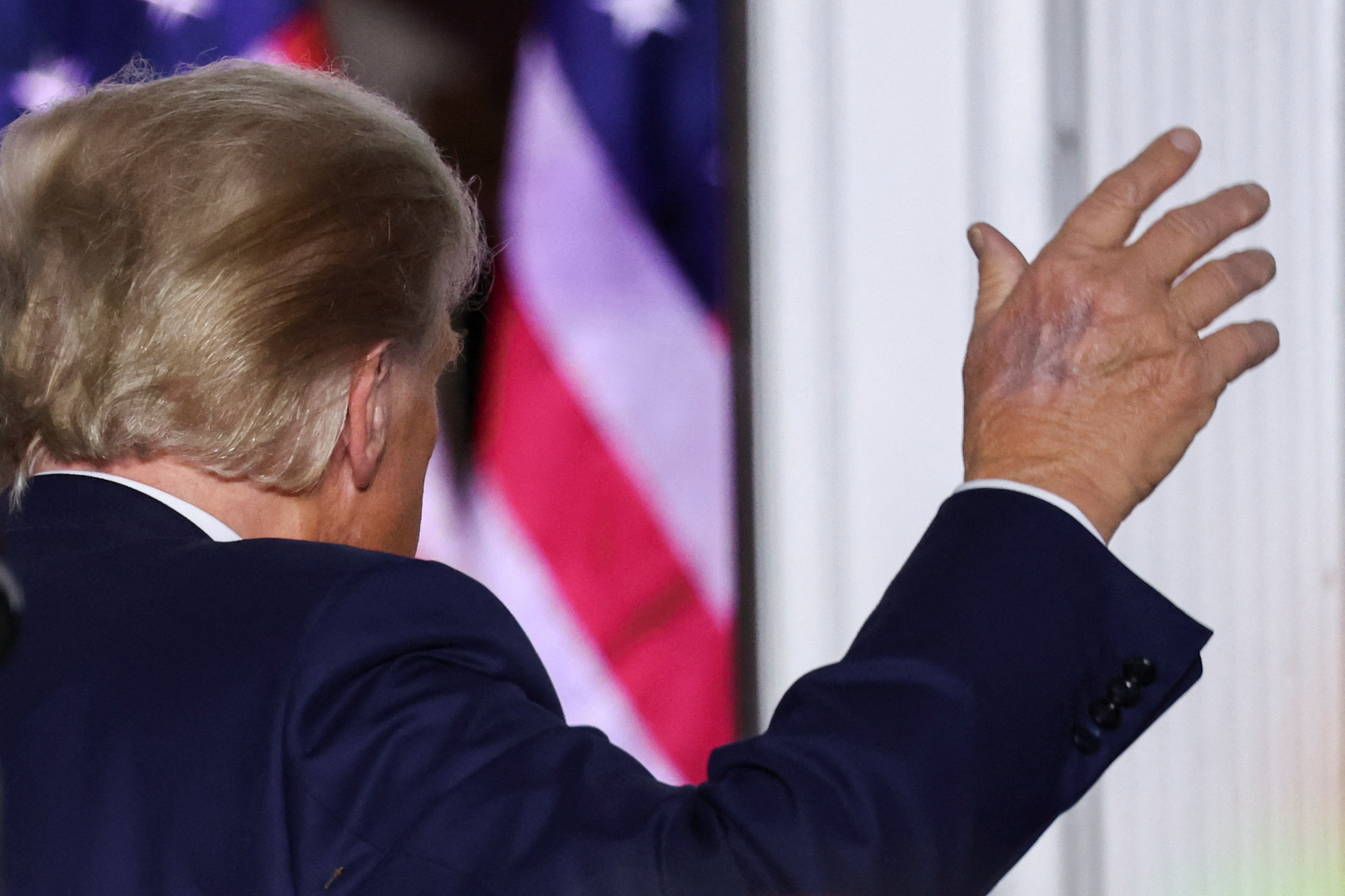 Former U.S. President Donald Trump waves during an event following his arraignment on classified document charges, in Bedminster