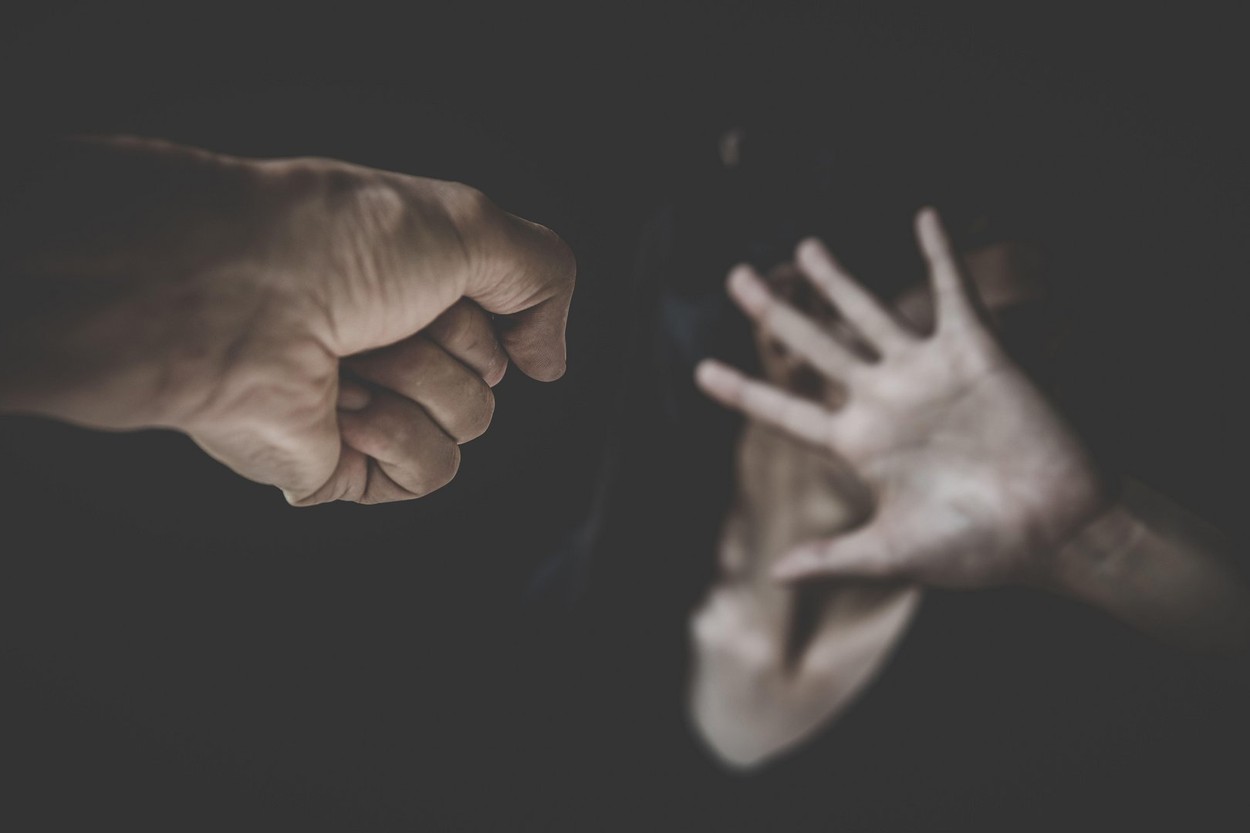 Domestic violence concept,Scared woman protecting from men aggression.  Stop violence against women, International women's day.