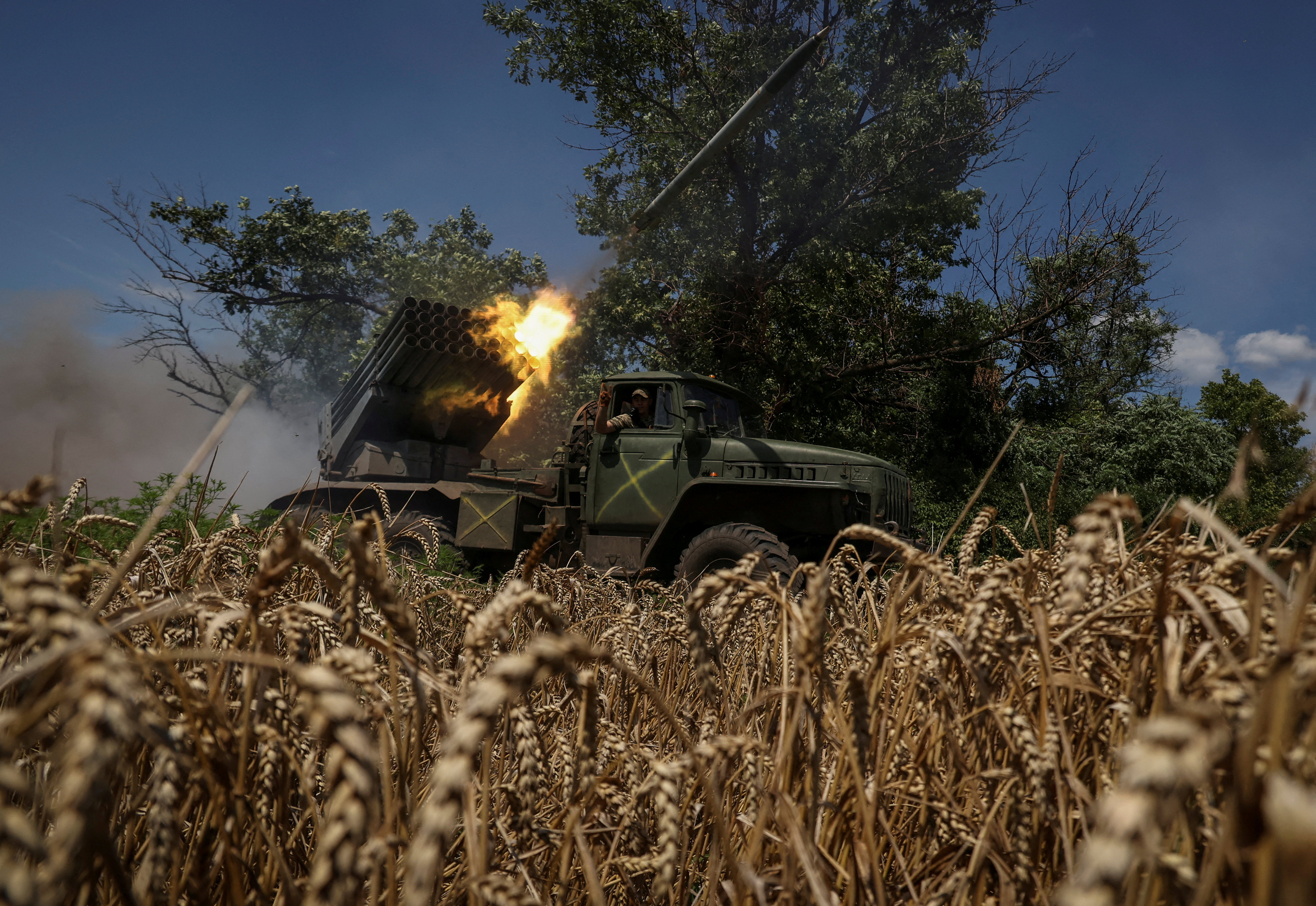 Ukrainian servicemen fire a BM-21 Grad multiple launch rocket system towards Russian troops in Donetsk region