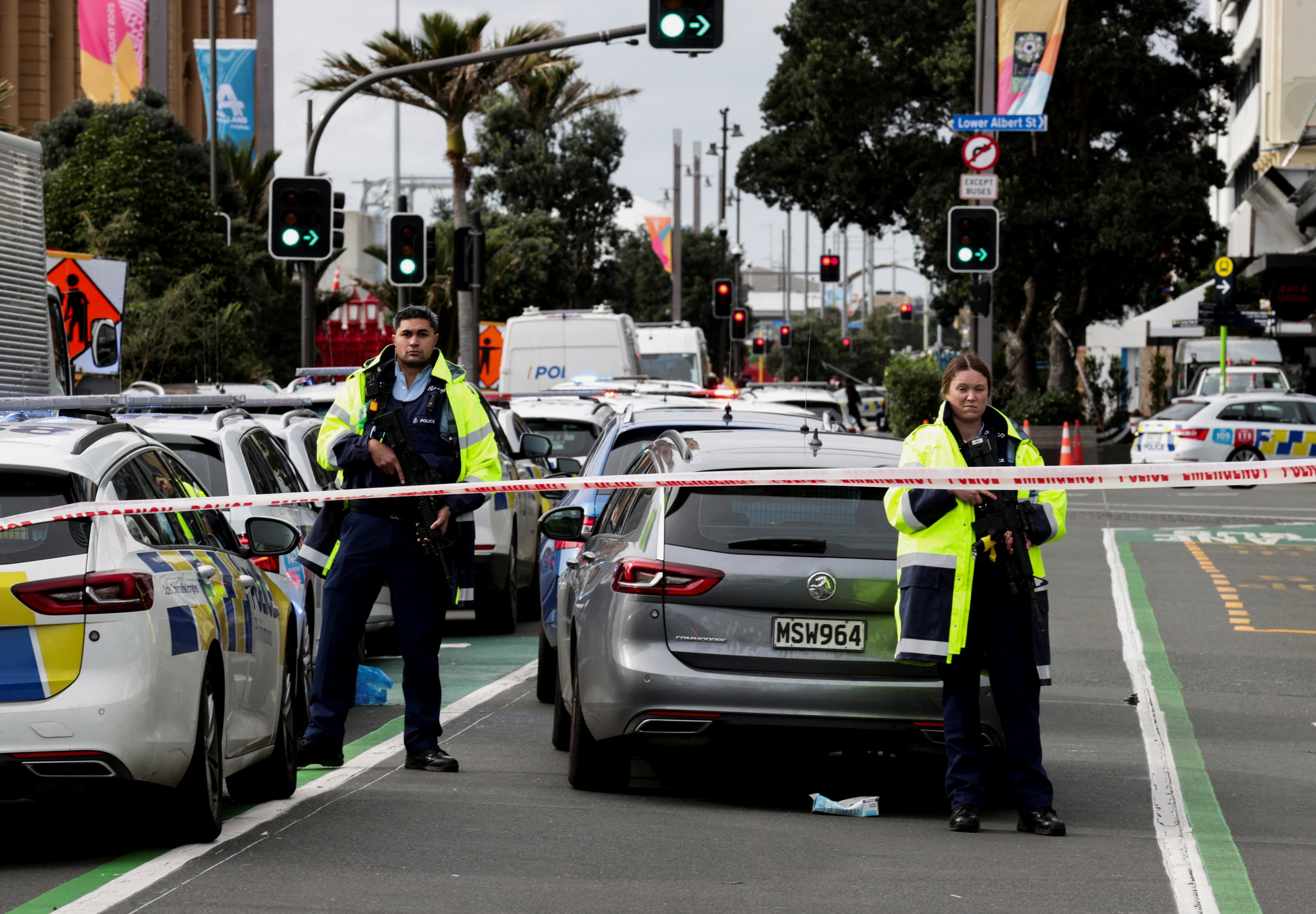 Armed police stand guard outside a building construction site following a shooting in the central business district in Auckland