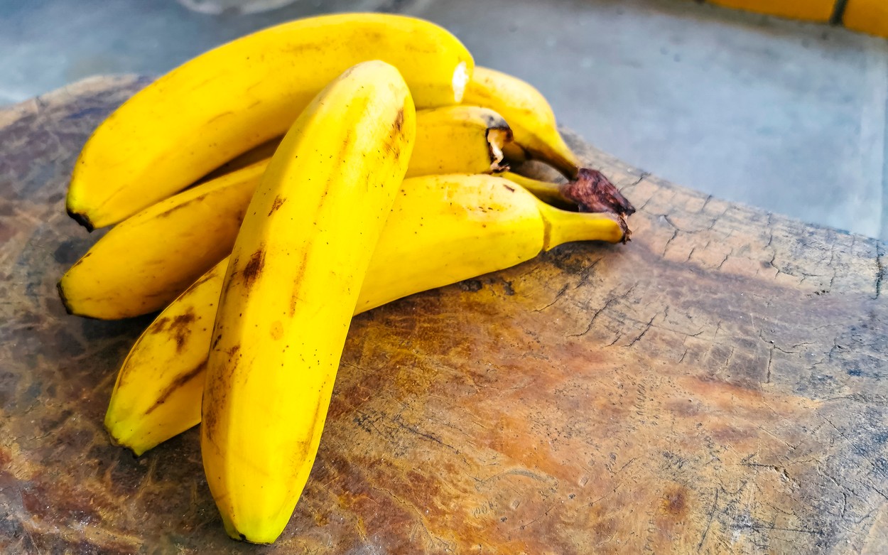 Bananas banana fruit fruits on wooden table Puerto Escondido Mexico.