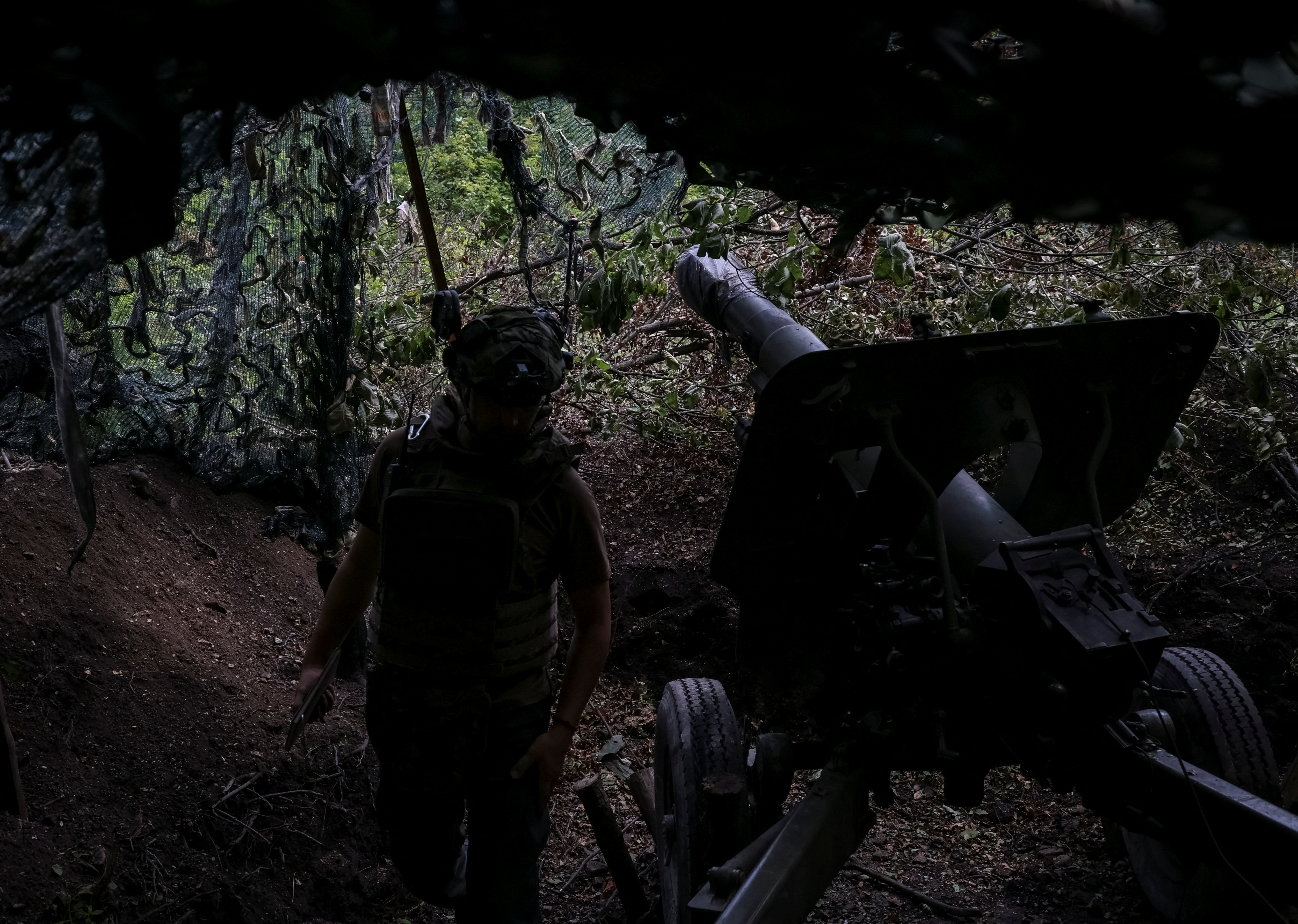 An Ukrainian serviceman of the First Brigade of the National Guard of Ukraine fires a howitzer towards Russian troops at a front line in Donetsk region