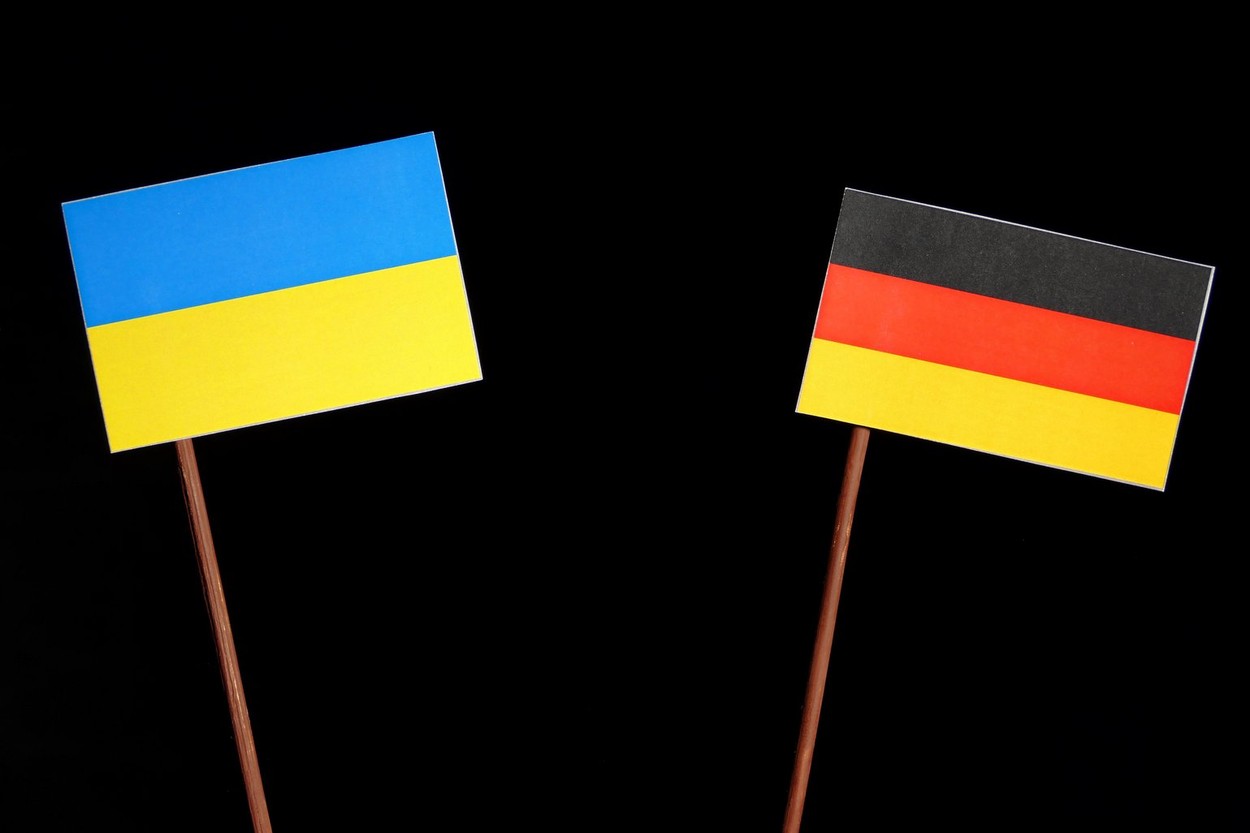 Ukraine flag with German flag isolated on black background