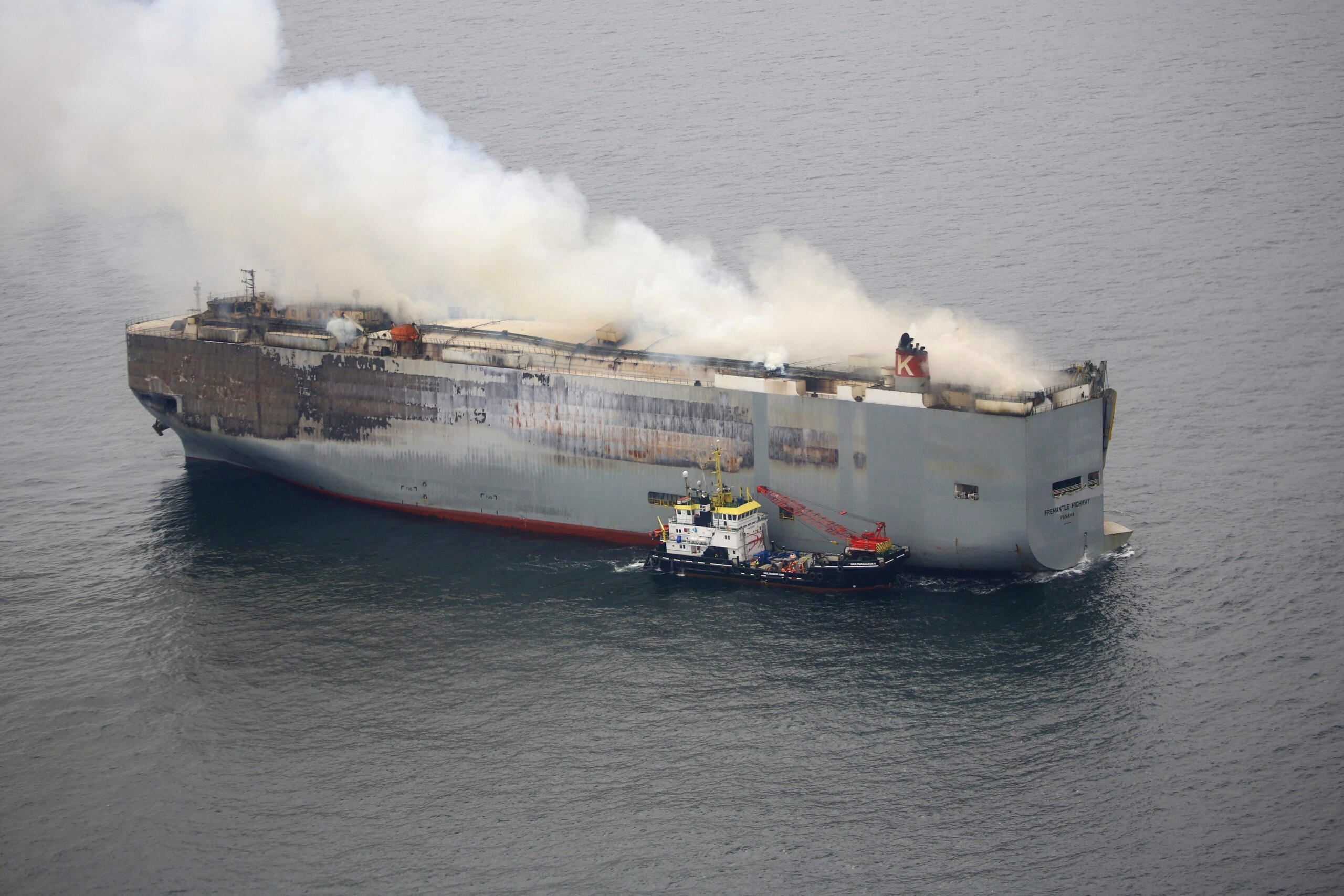 Smoke rises from burning cargo ship Fremantle Highway, at sea