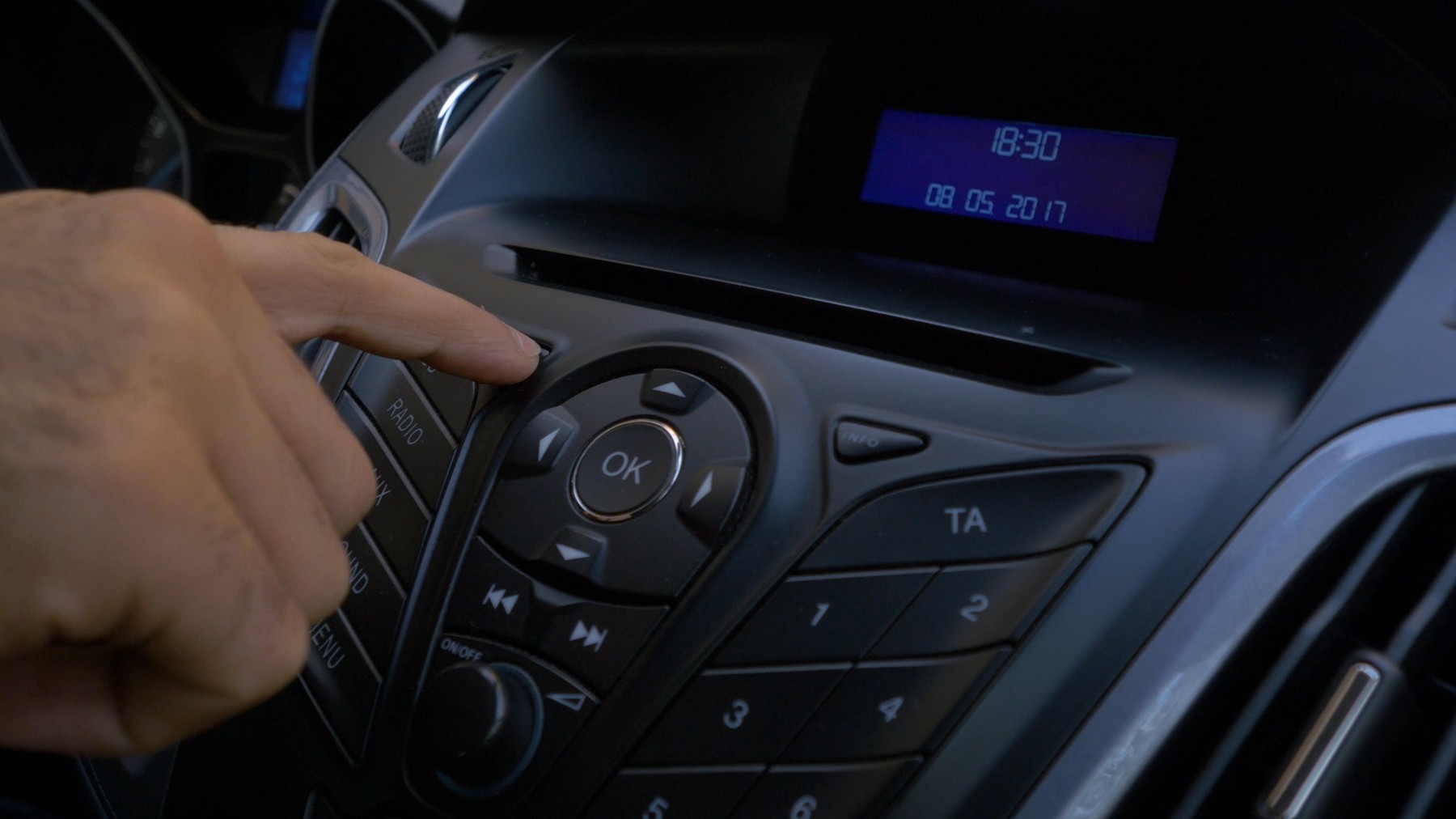 Man's hand puts the disk into the car player. Button control for compact disk player in a car. Hand puts the disk into the radio car