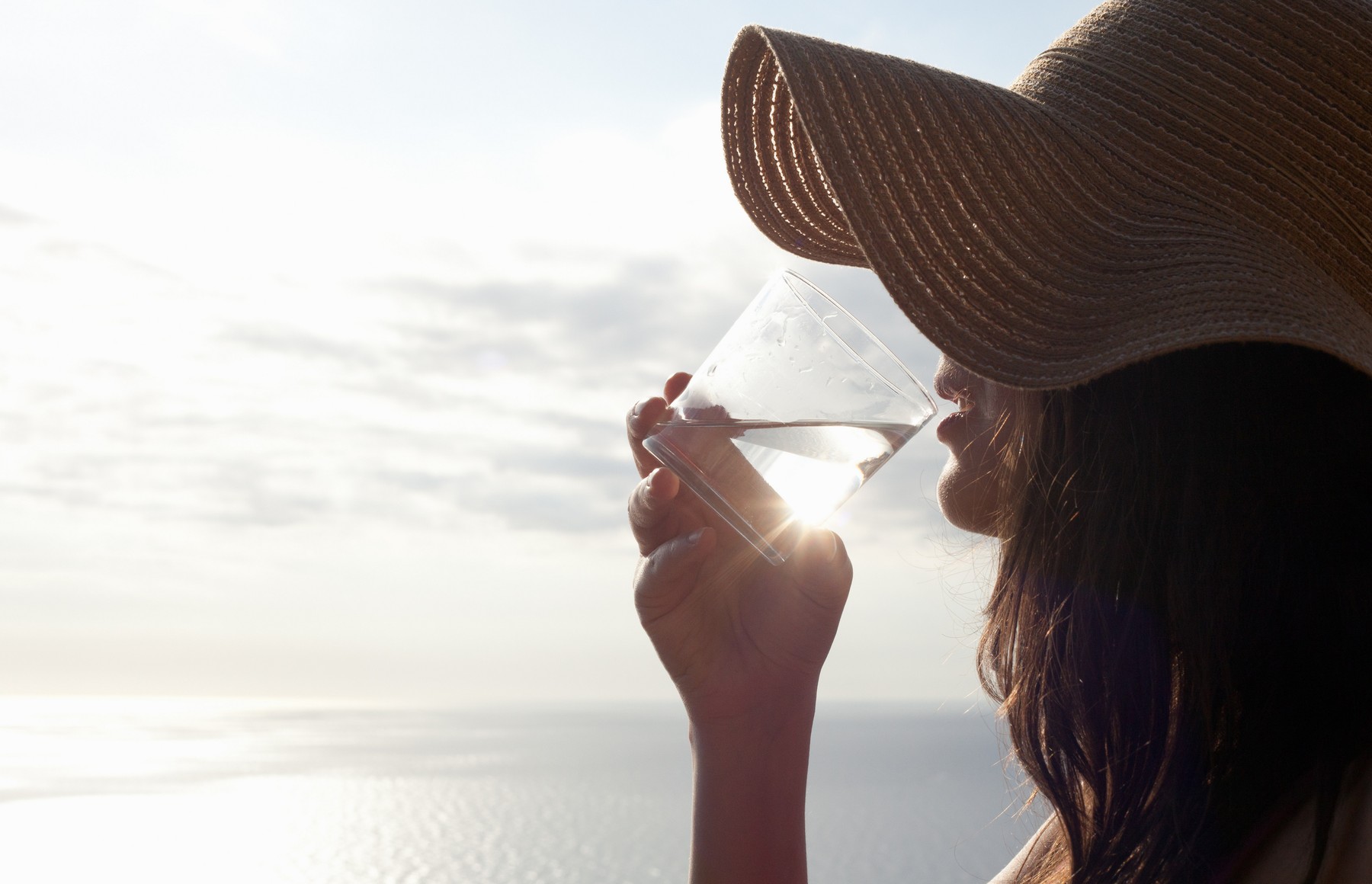 Woman drinking glass of water outdoors