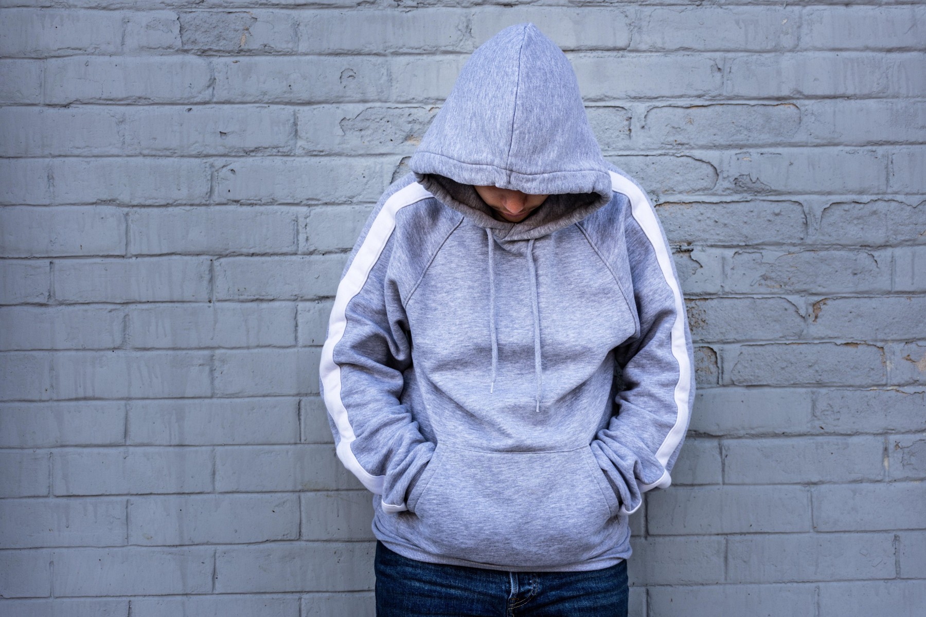 Lonely Man Leaning against an urban wall