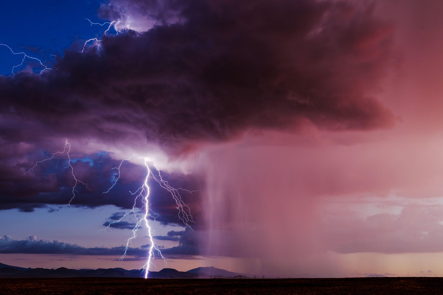 Sunset lightning bolt from a storm near Flagstaff, Arizona