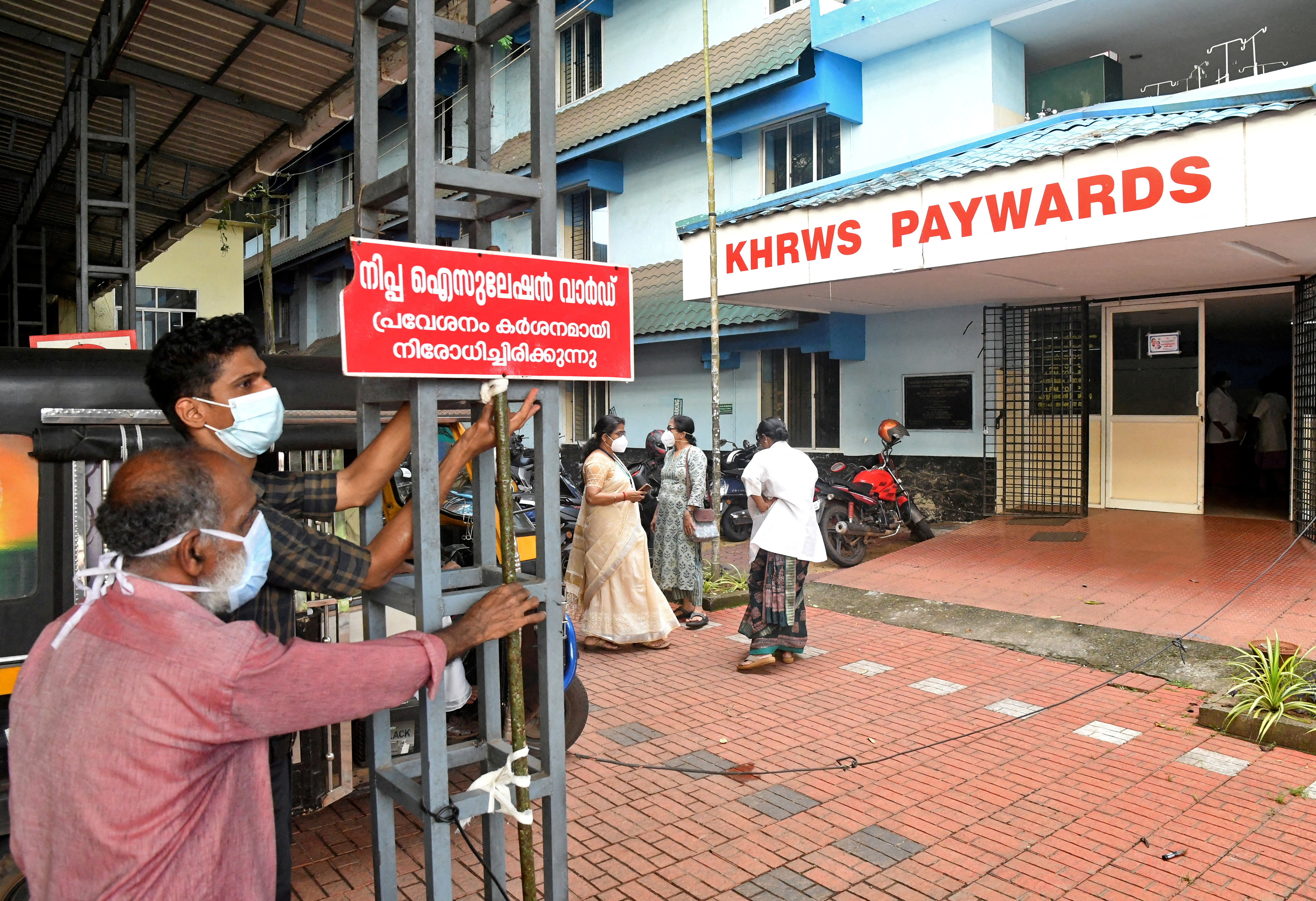 FILE PHOTO: Staff install a sign reading "Nipah isolation ward, entry strictly prohibited" at a hospital where a ward is being prepared for suspected Nipah virus patients in Kozhikode