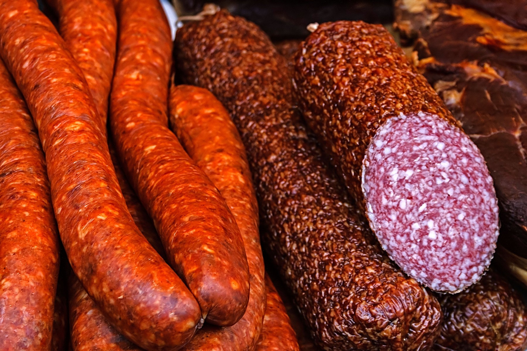 Sausages and salami cut, placed on a table.
