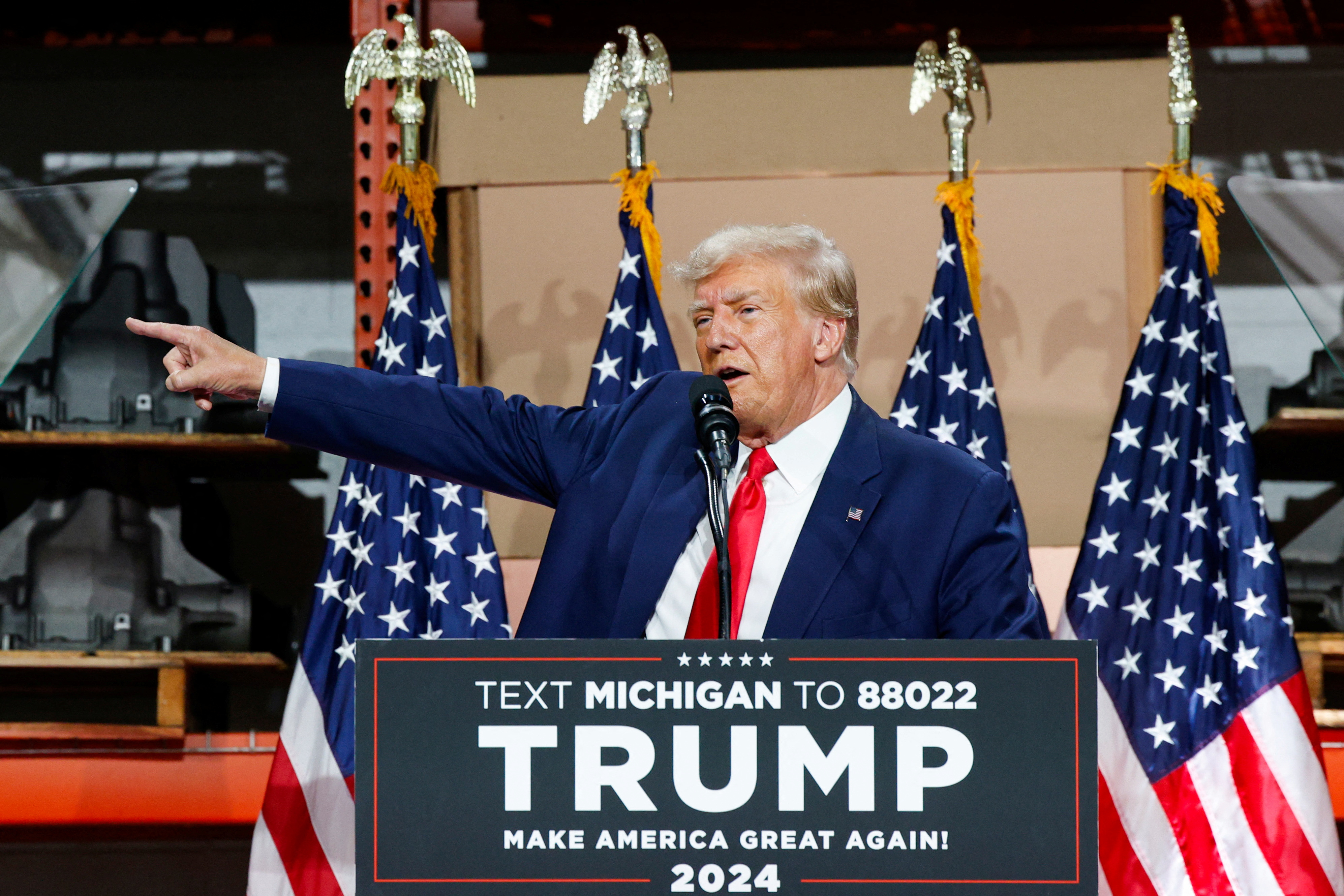 Former U.S. President and Republican presidential candidate Trump addresses auto workers as he skips the second GOP debate, in Clinton Township, Michigan