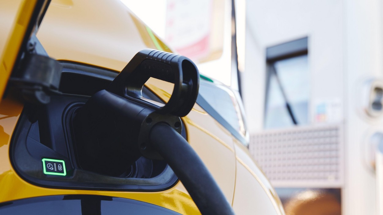 Plugged in electric car in at a EV charging station using a rapid-charger