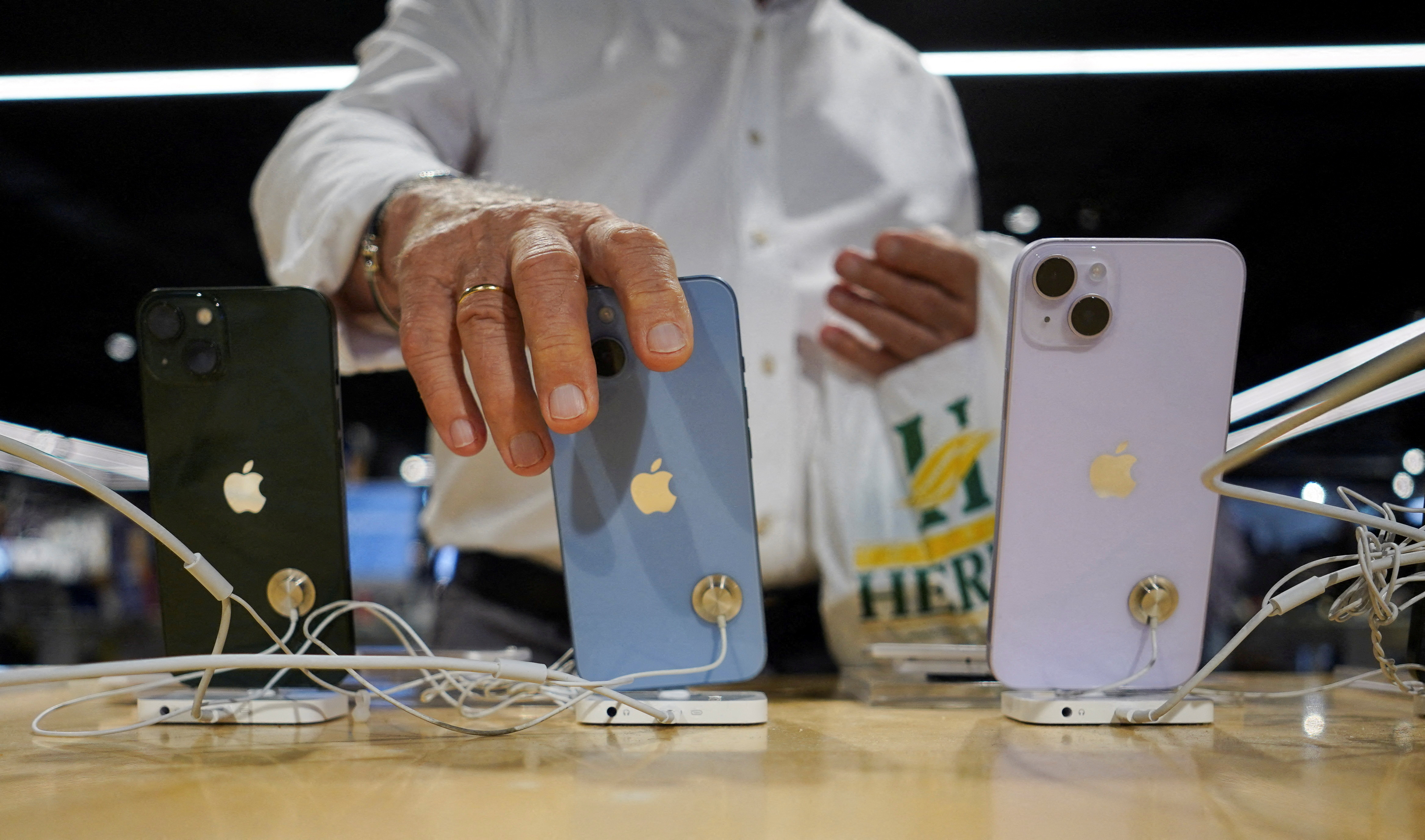 FILE PHOTO: A man looks at Apple iPhones at a shop in Bilbao