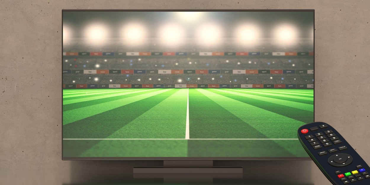 Sports stadium on TV screen and television remote control, watching soccer football matches, sports channels. 3d illustration