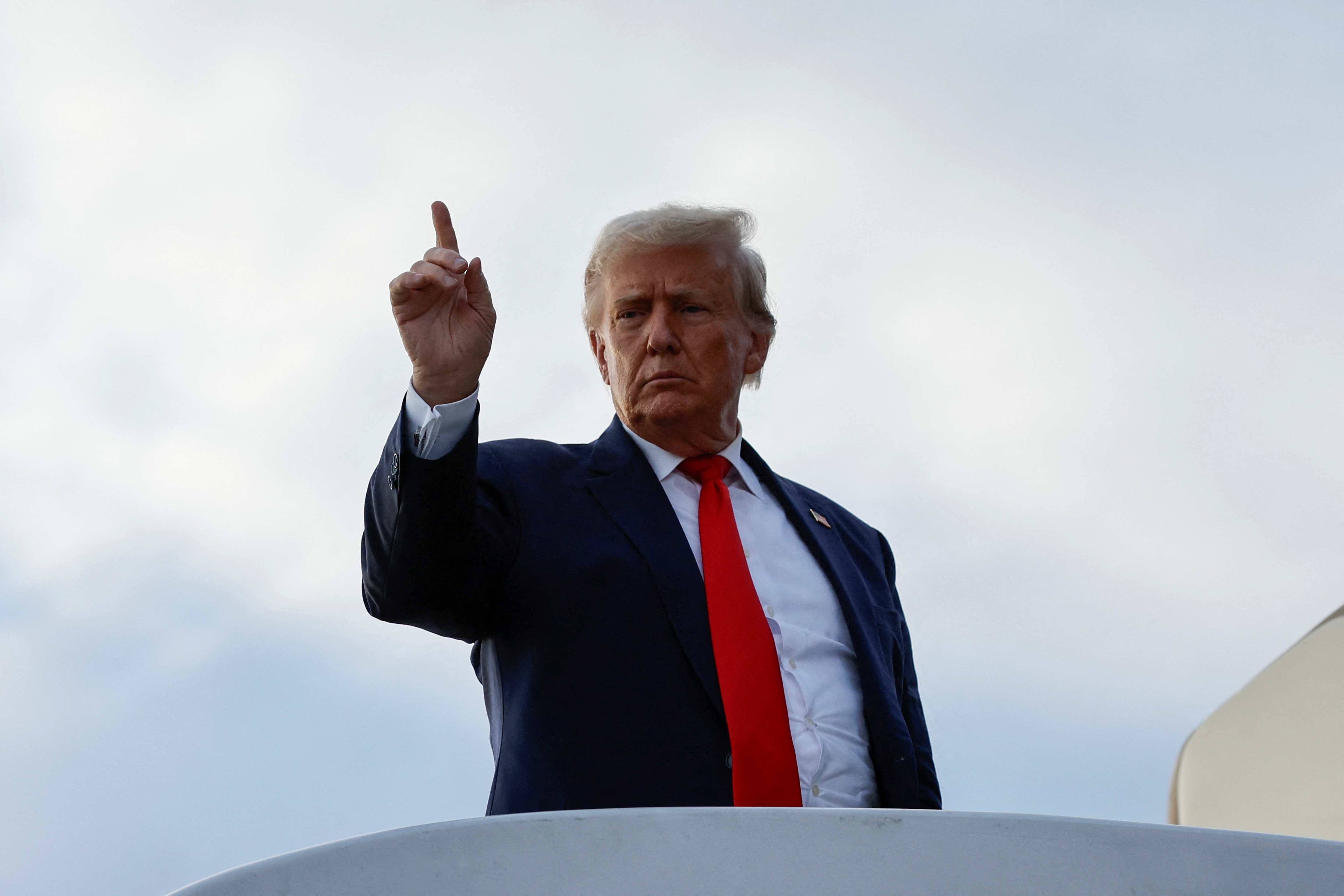 Former U.S. President and Republican presidential candidate Donald Trump boards his plane to depart from Eastern Iowa Airport