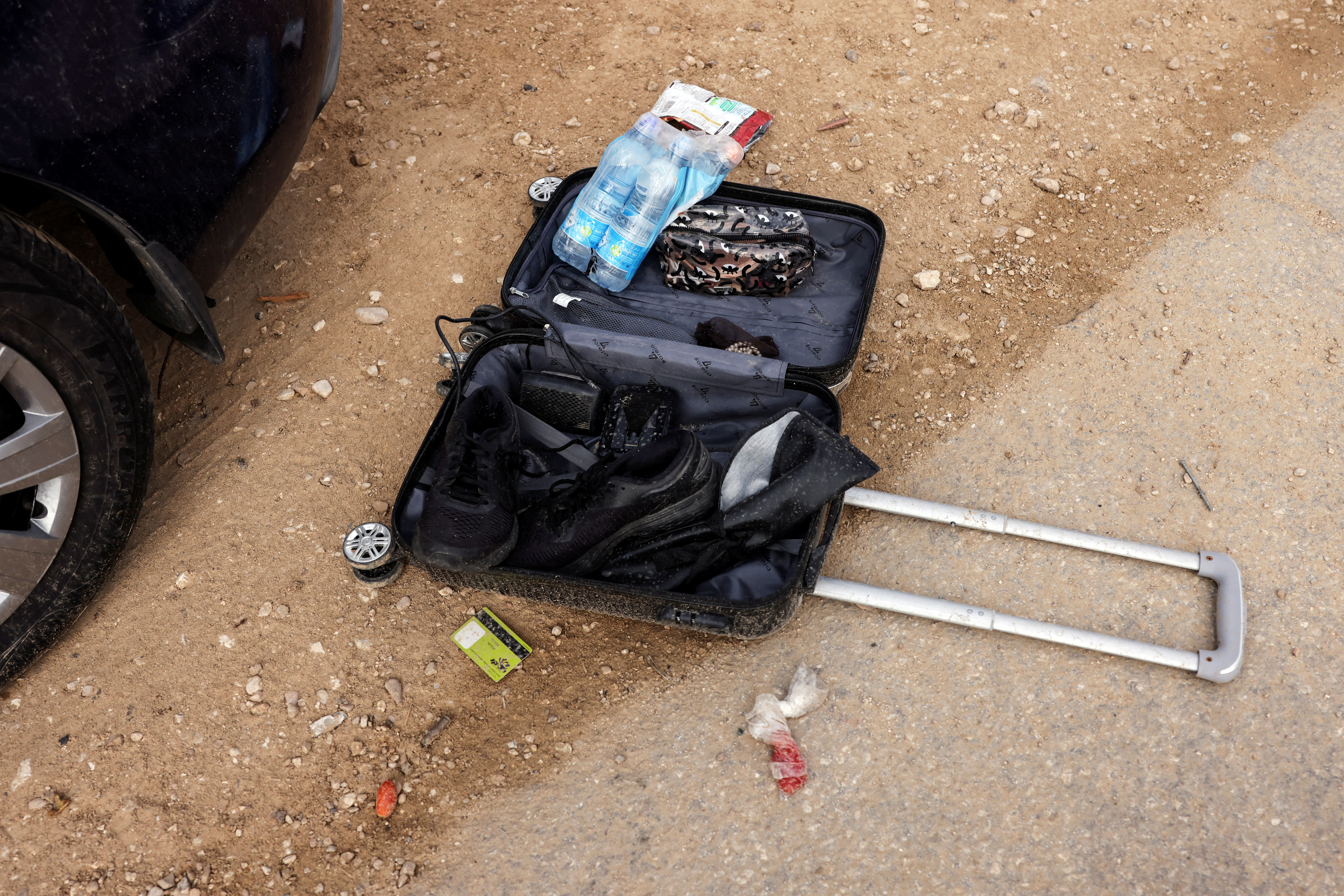 Ammunition and bullet shells are seen near someone's personal belongings in an abandoned carpark near where a festival was held before an attack by Hamas gunmen from Gaza that left at least 260 people dead, by Israel's border with Gaza in southern Israel