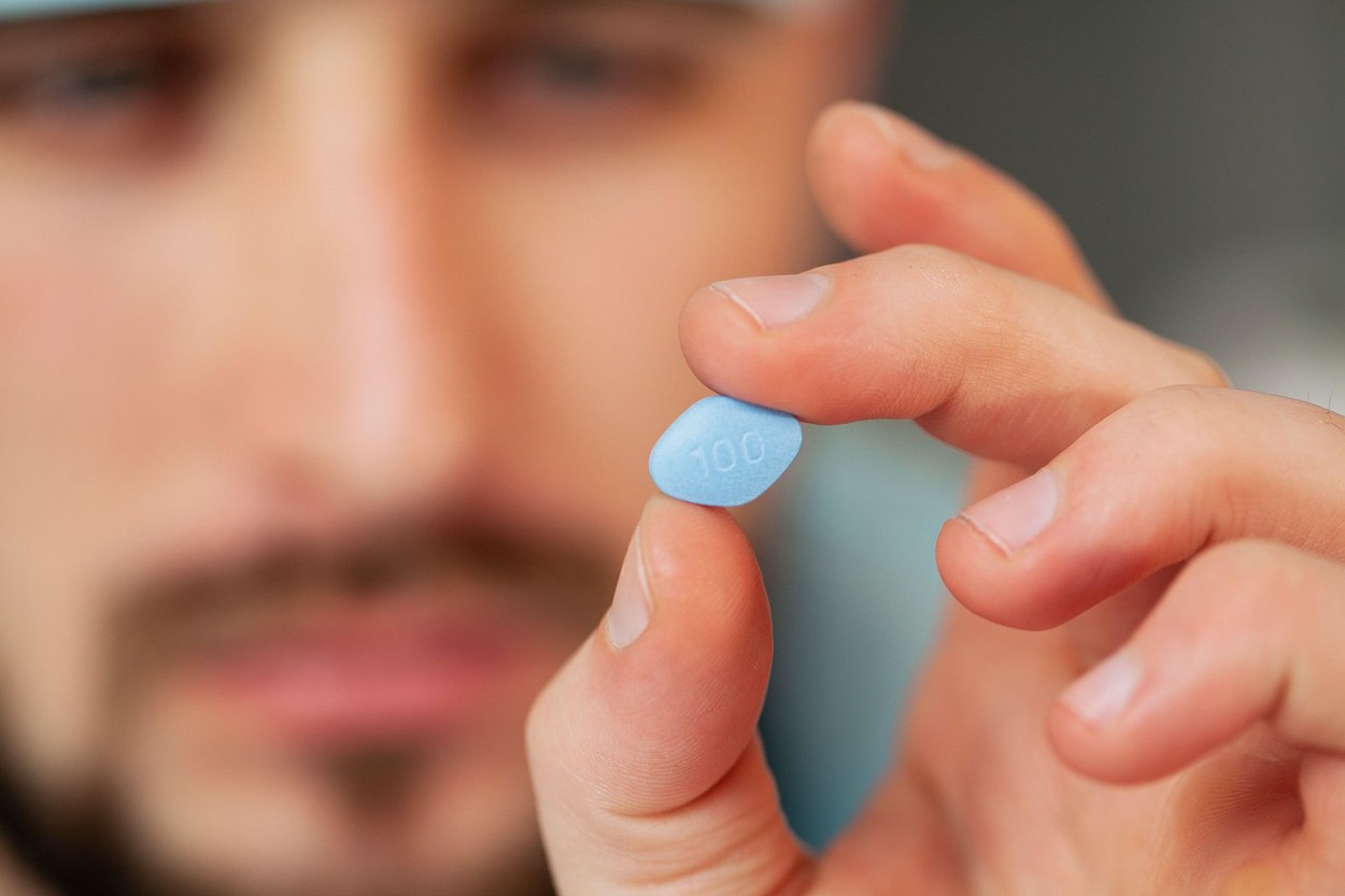 Doctor holds a pill for men's health