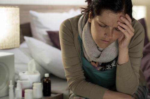 Ill woman with medicines suffer flu headache
