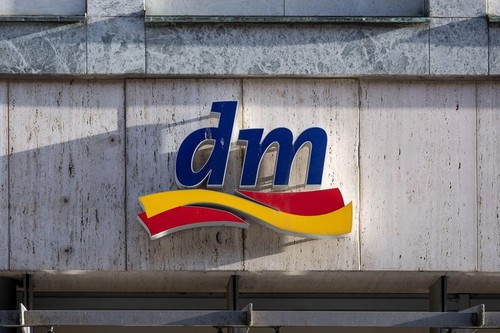 Lubeck, Germany, January 15, 2022: dm logo in sunny side light on a building facade, brand mark of the drogerie markt, a chain of retail stores offeri